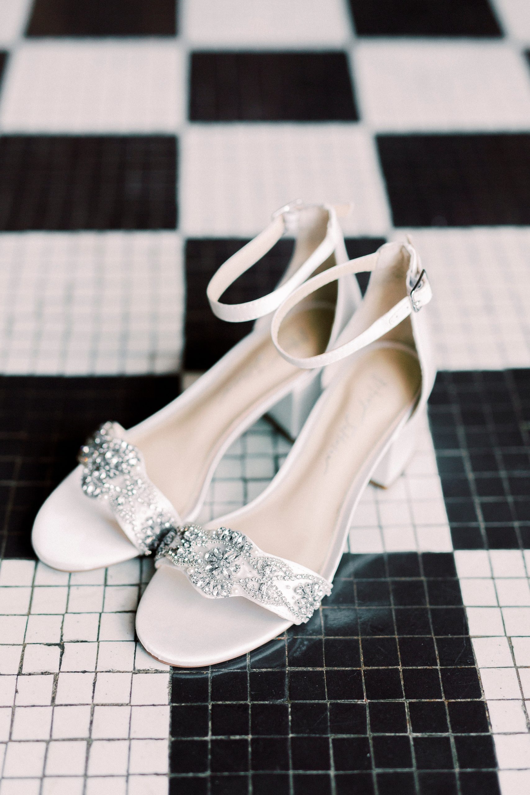 bride's shoes on black and white floor at the gold wedding bands for Cadillac Service Garage