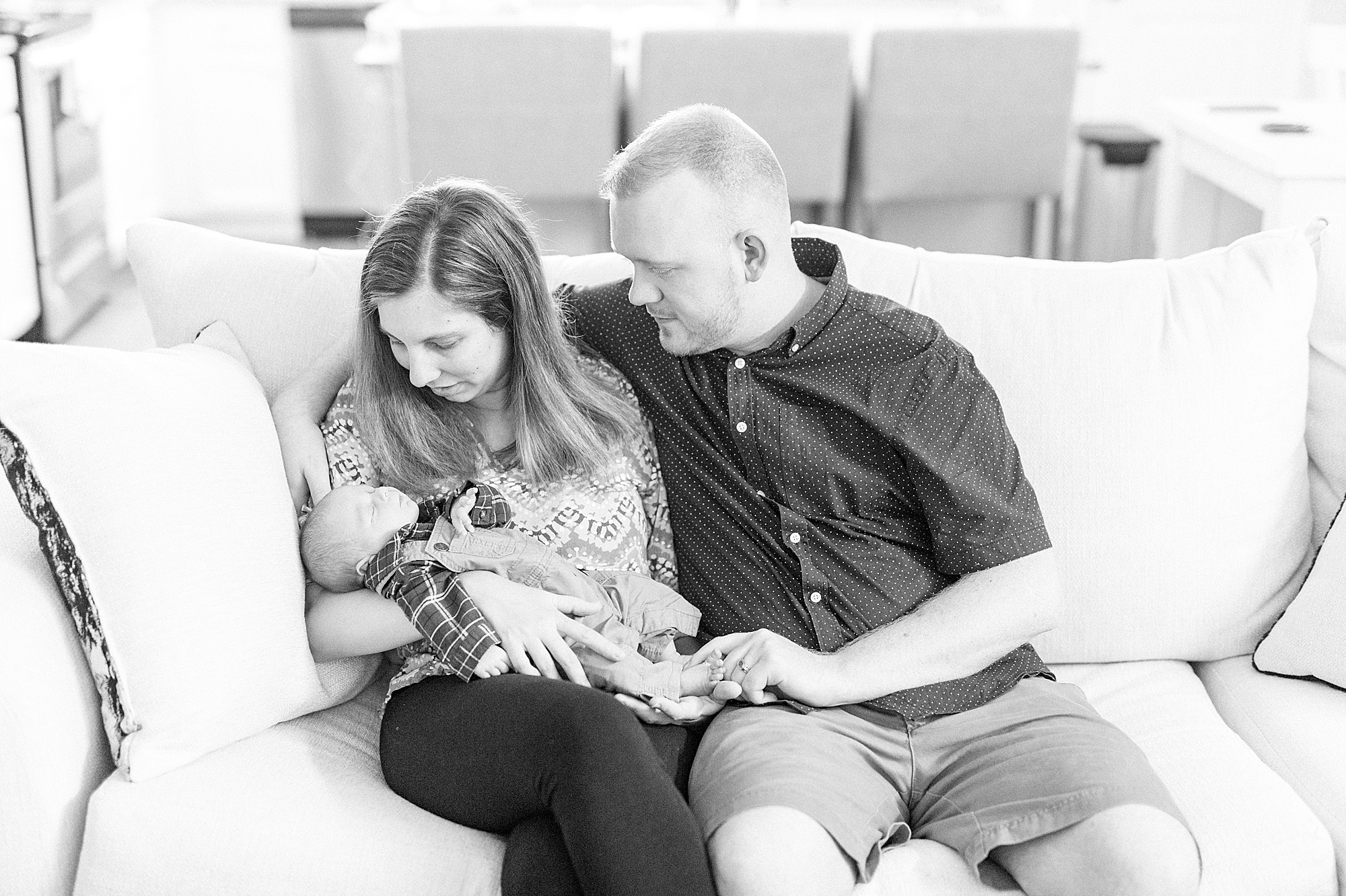 new parents look at son during lifestyle newborn session