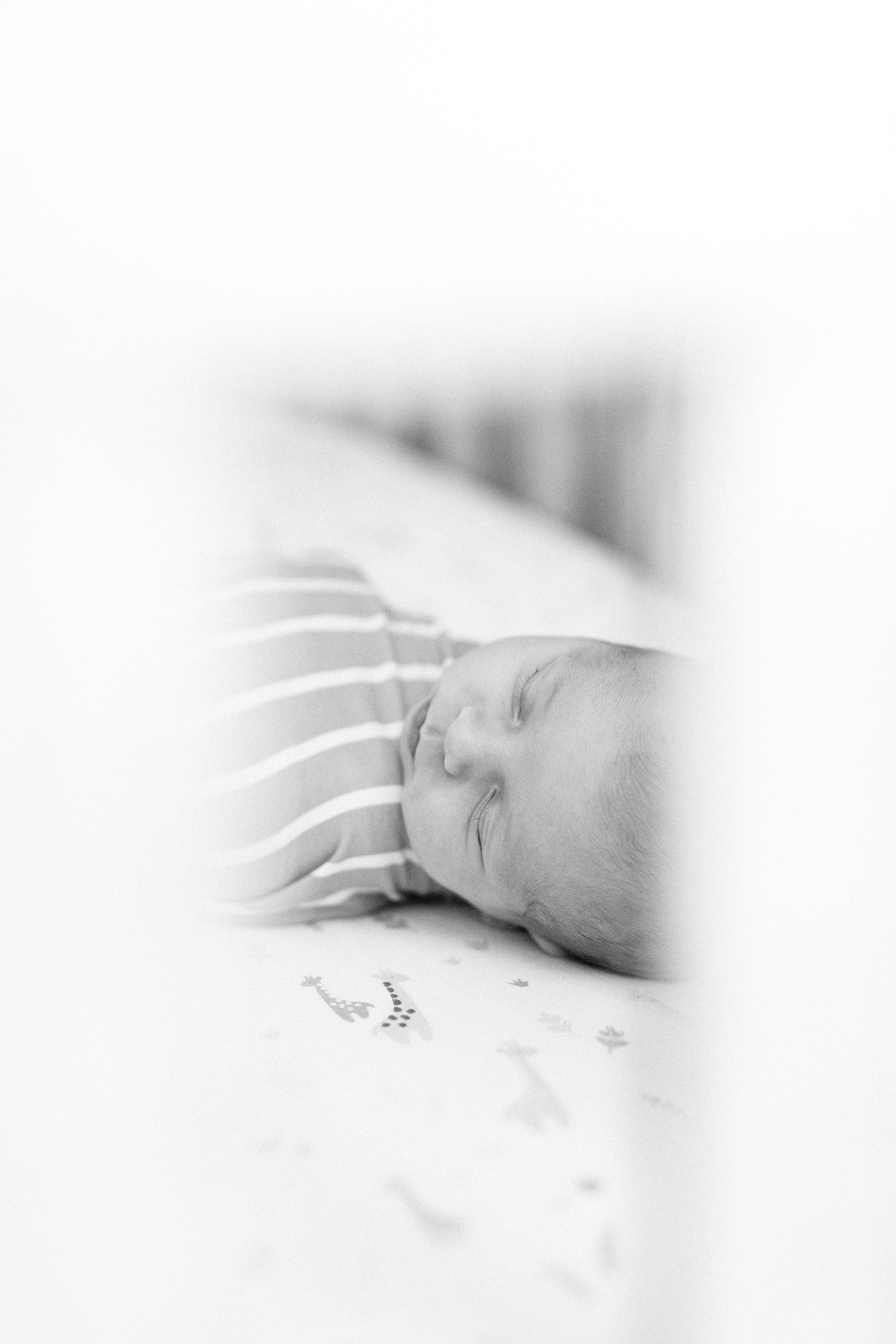 baby sleeps in crib during newborn photos at home