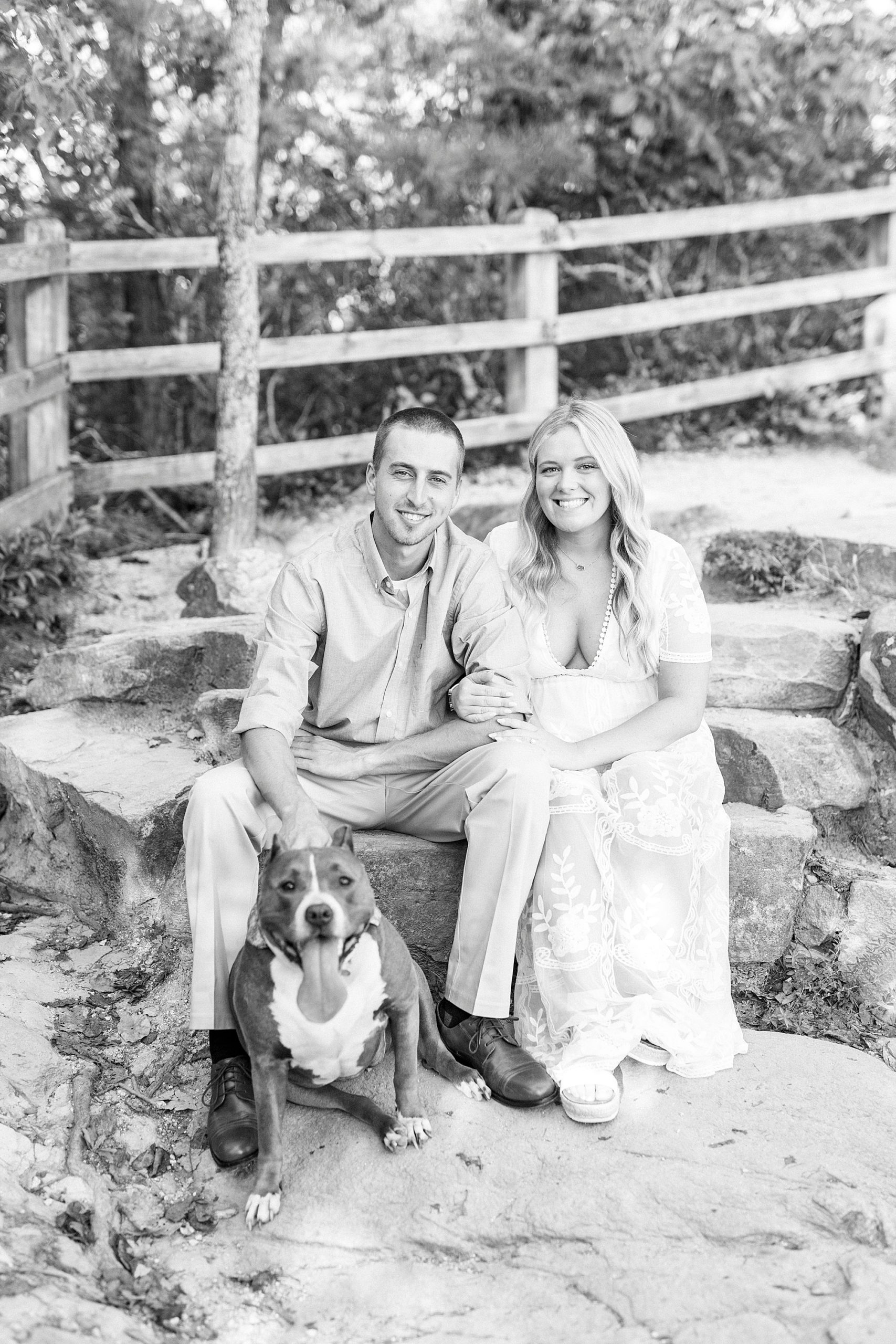 couple sits with dog during Mount Airy engagement session