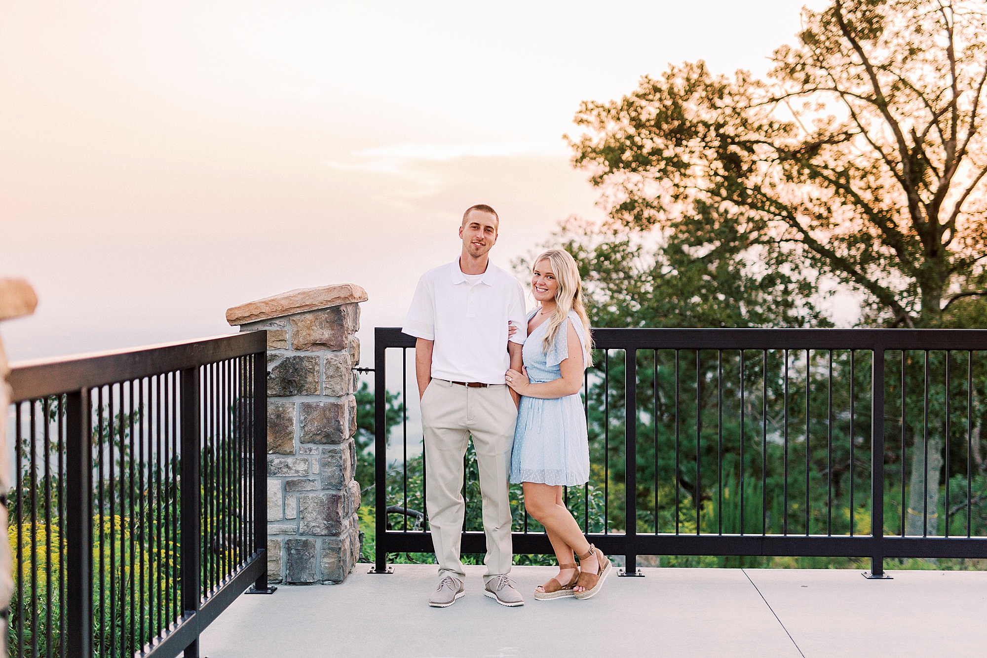 engaged couple poses on mountain overlook during NC engagement session