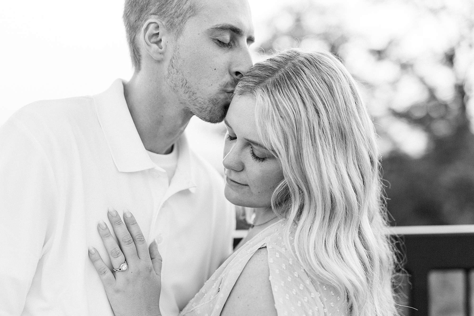 groom kisses bride's forehead during Mount Airy engagement session