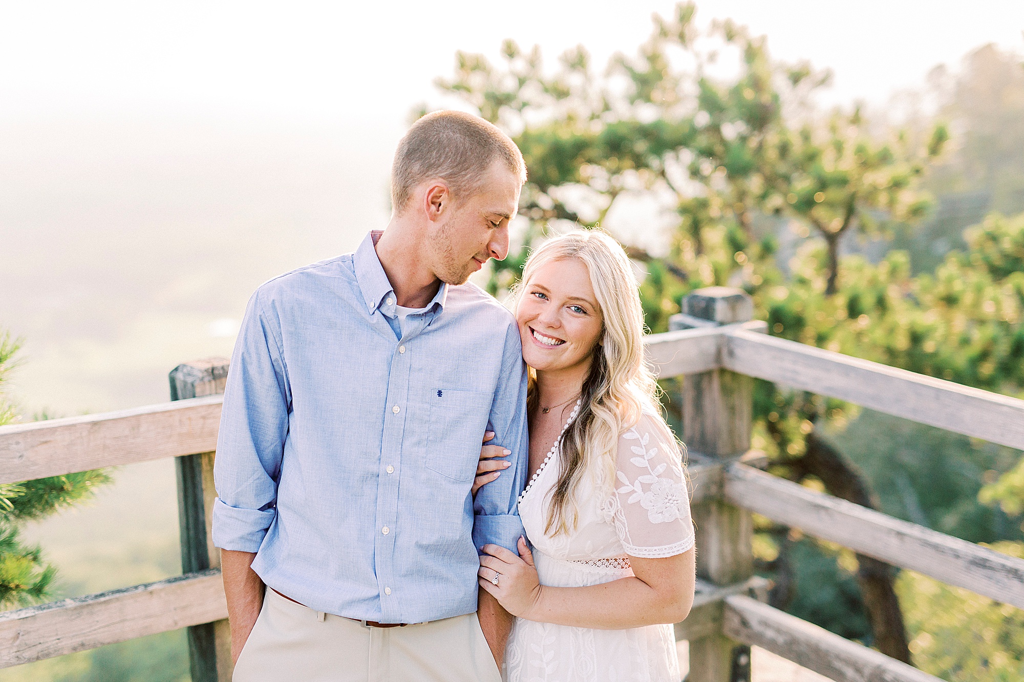bride leans into groom's arm during Mount Airy engagement session
