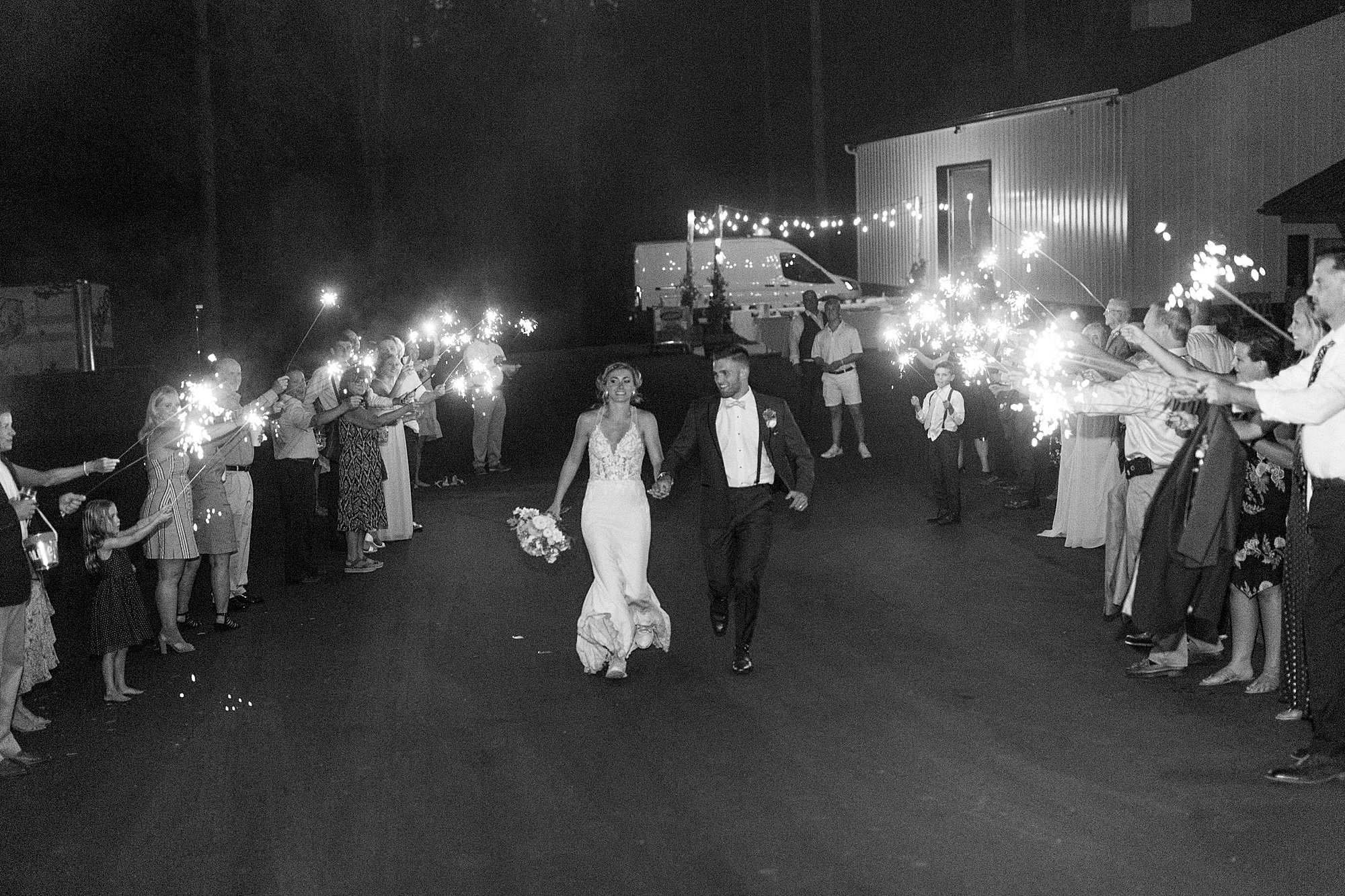 bride and groom leave wedding reception during sparkler exit
