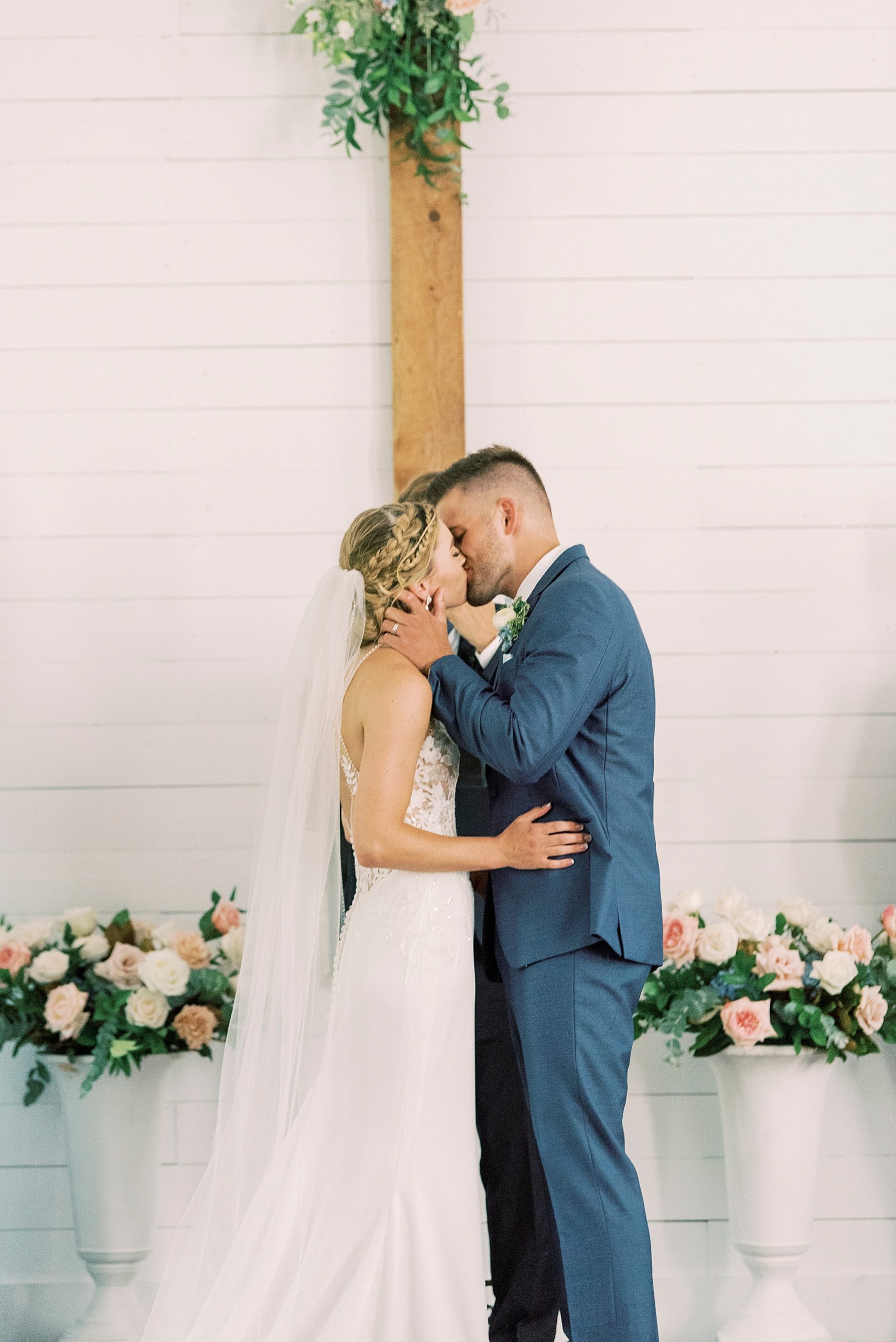 couple kisses during traditional church wedding in Winston-Salem NC