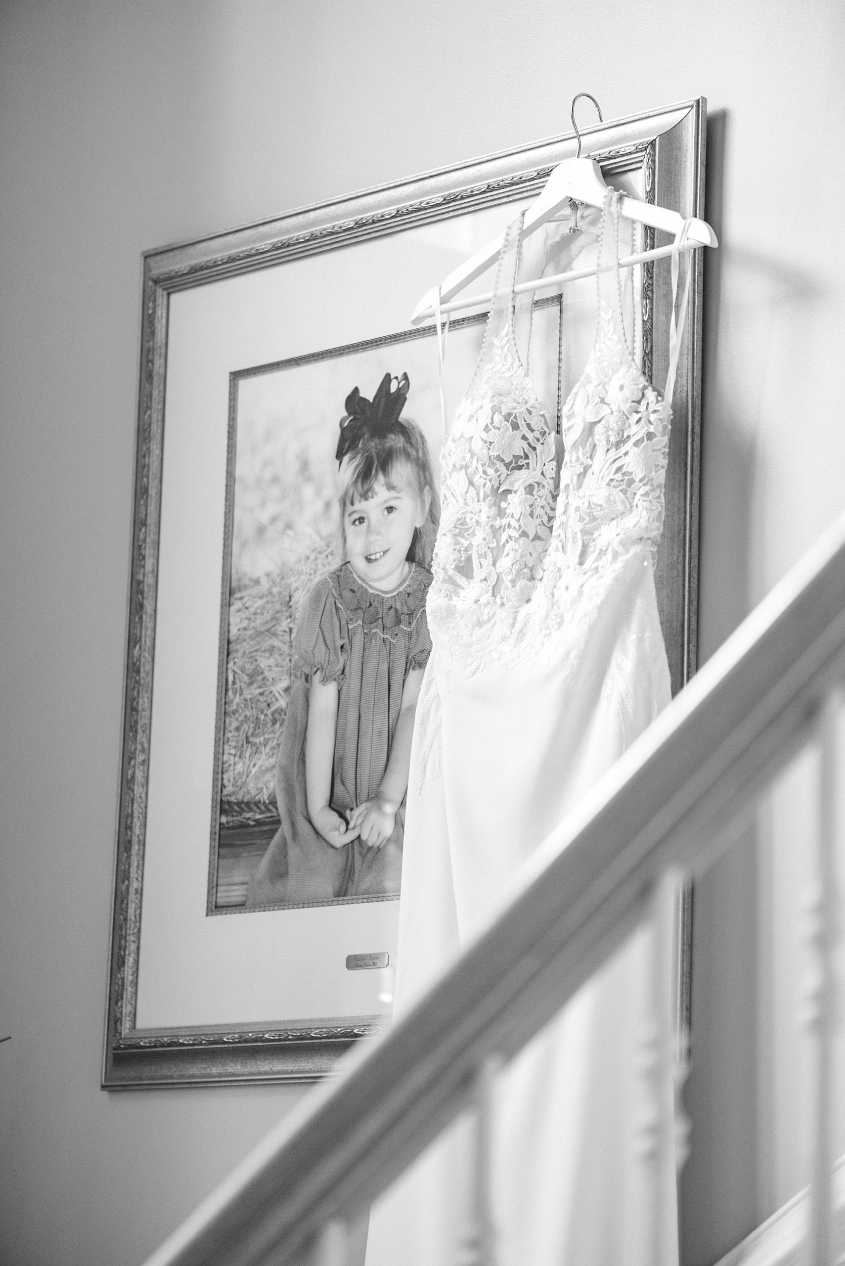 bride's dress hangs on childhood photo