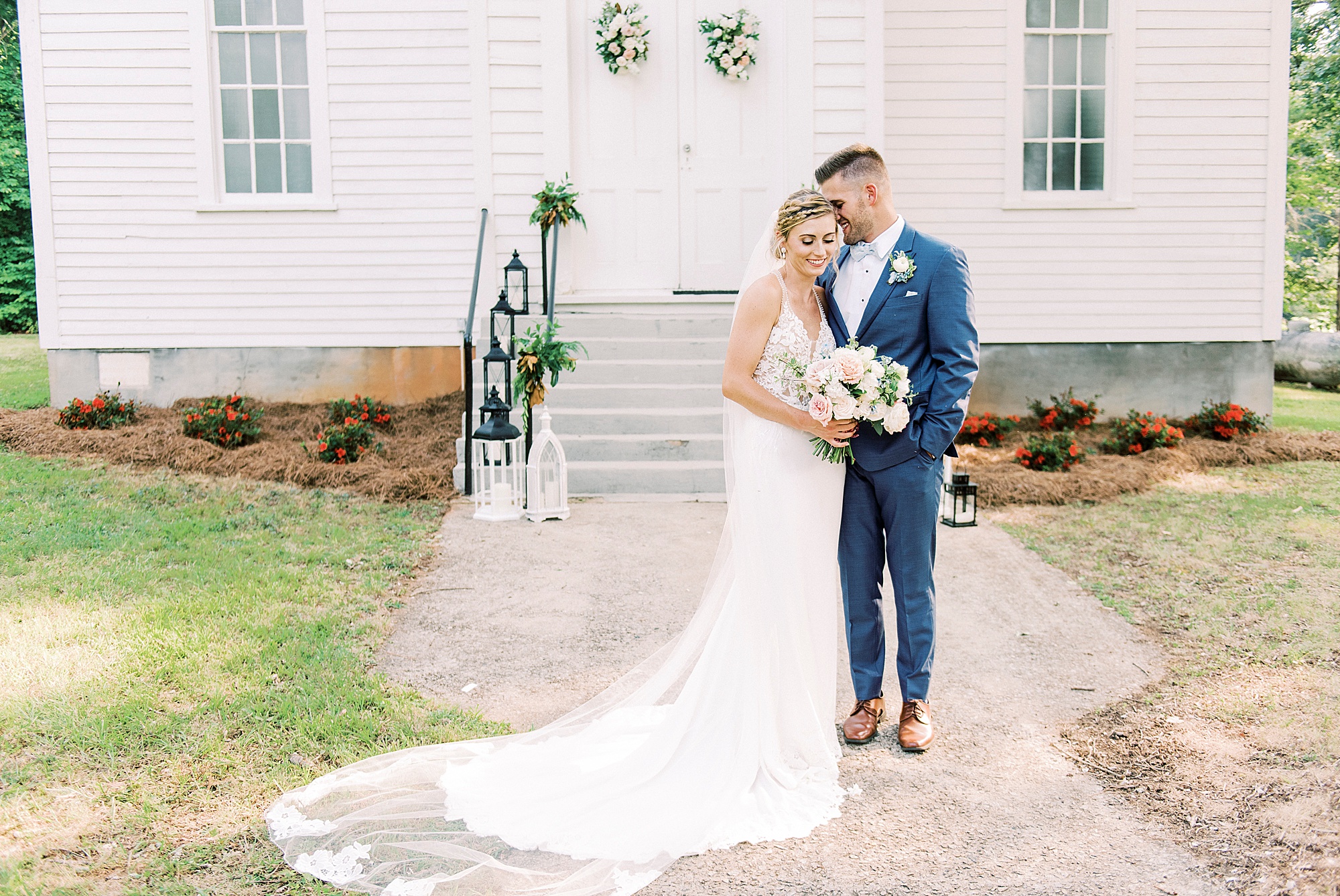 groom whispers in bride's ear during portraits outside Winston-Salem NC church