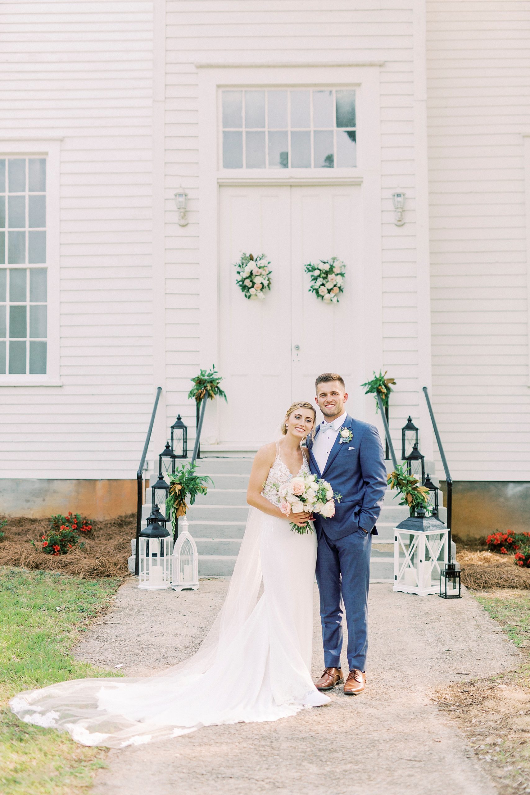 bride and groom pose outside Winston-Salem NC church