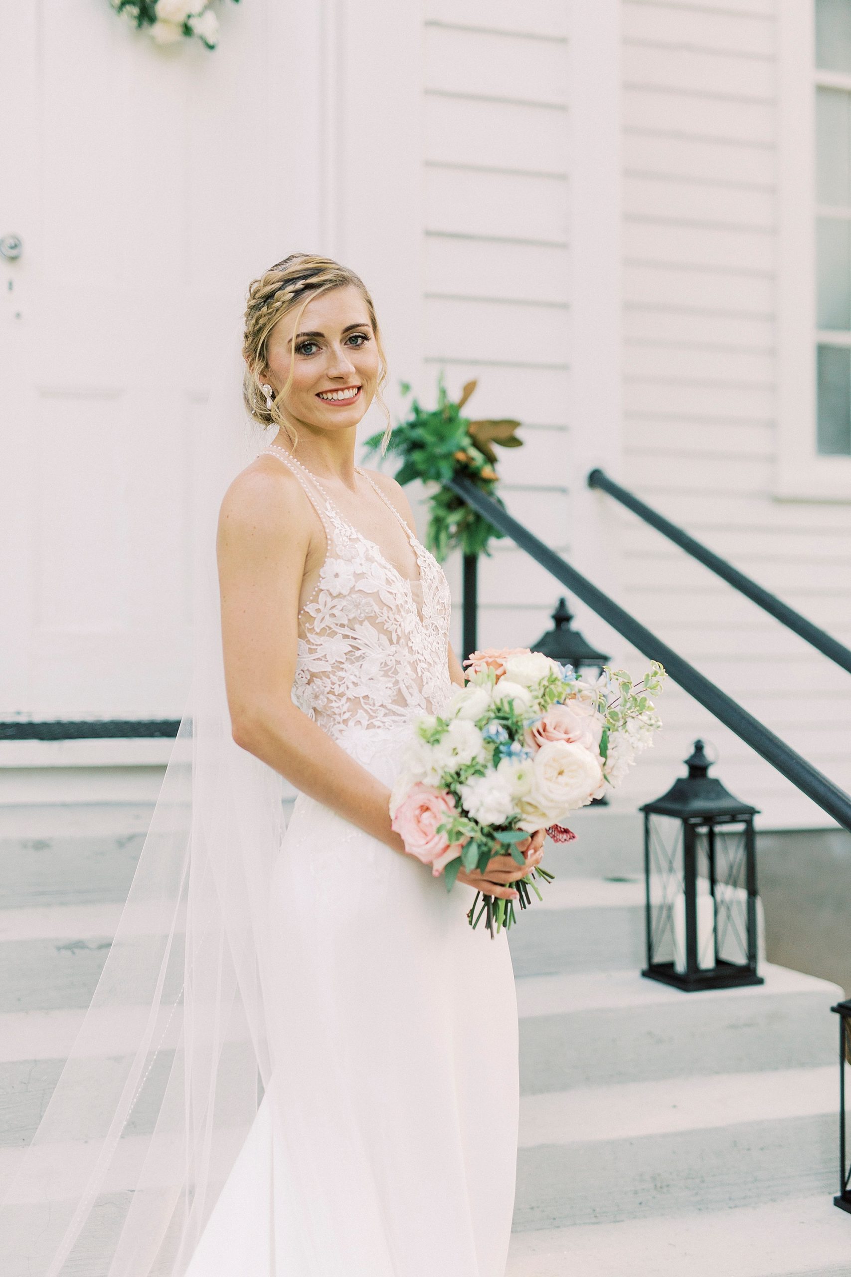 bride holds bouquet looking over shoulder