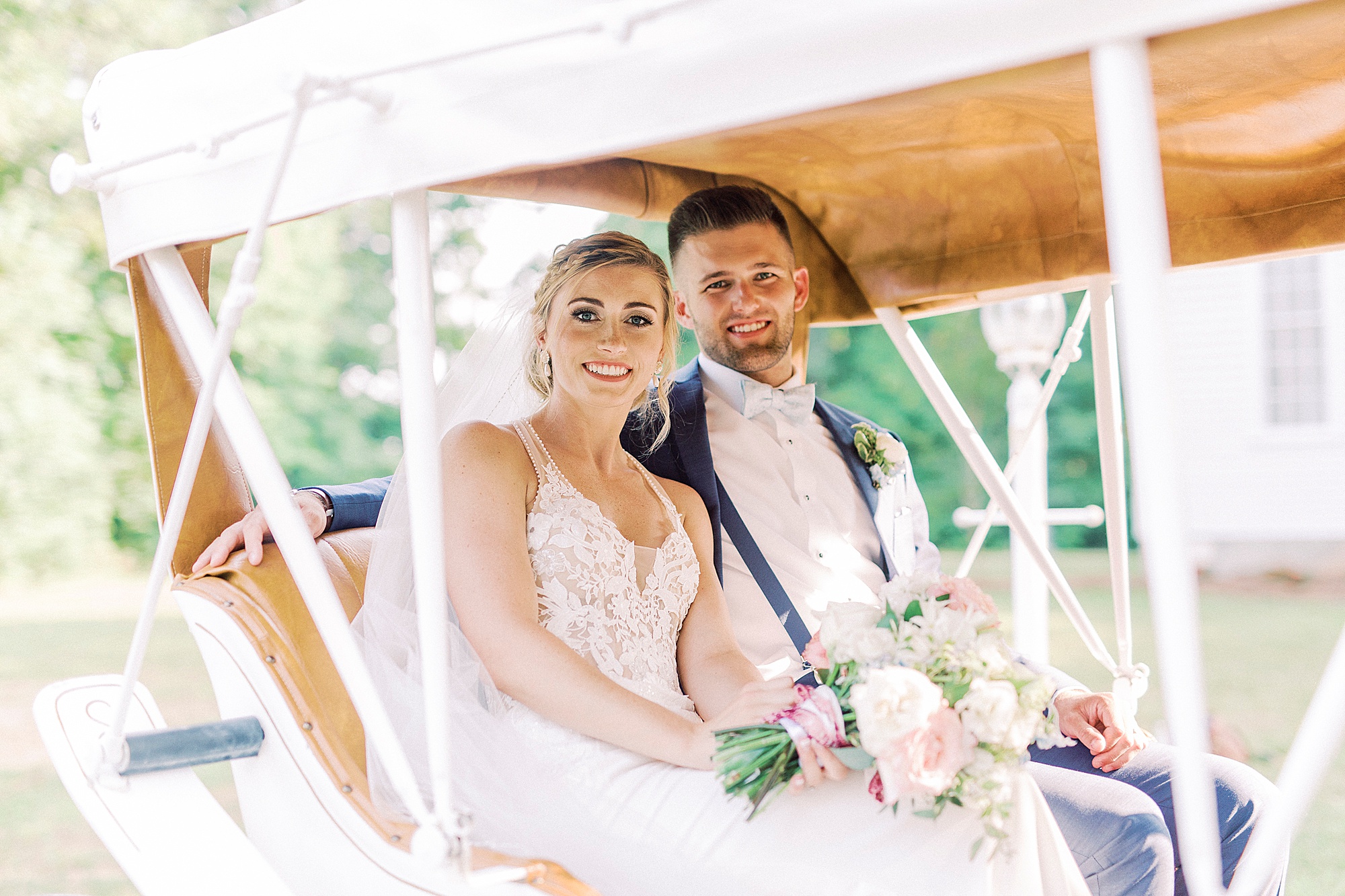 newlyweds ride in carriage after Winston-Salem NC wedding ceremony