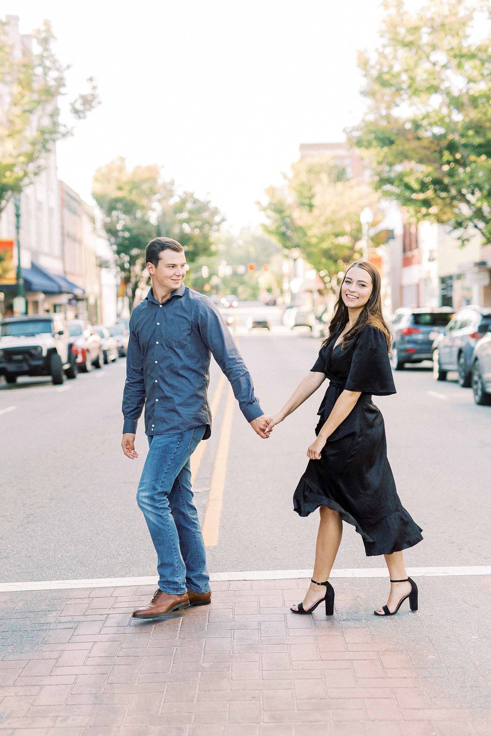 engaged couple walks through street in Concord NC