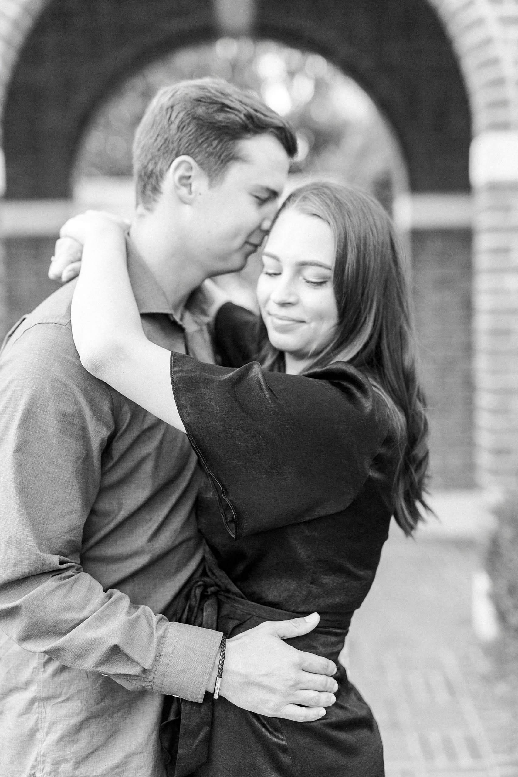 groom nuzzles bride's forehead during Downtown Concord engagement session