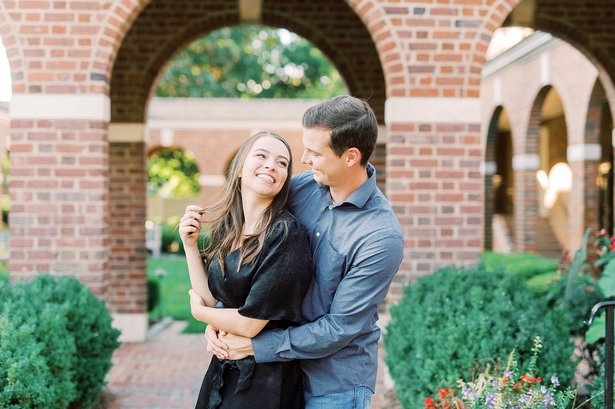 groom makes bride laugh during engagement session