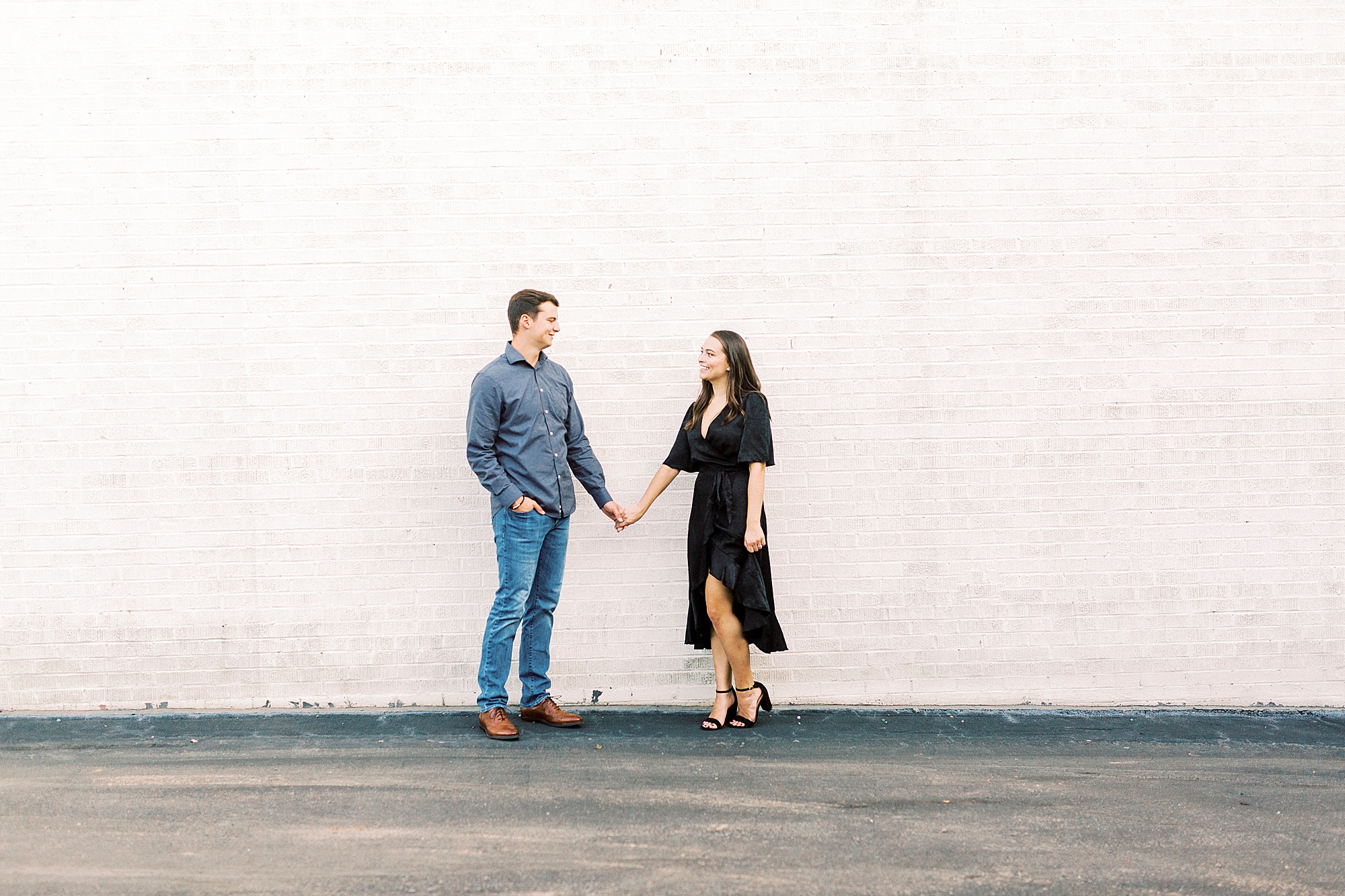 Downtown Concord engagement session against white wall