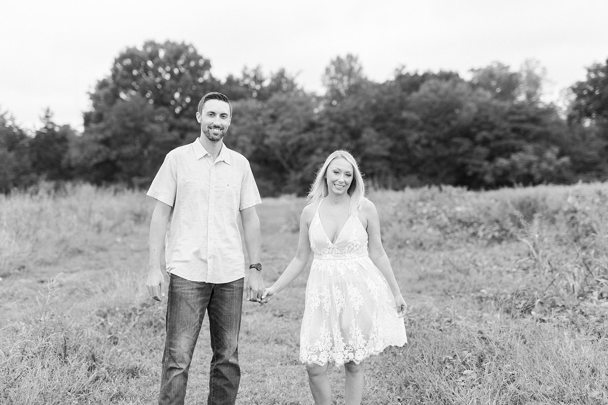 couple holds hands walking through Hodges Family Farm