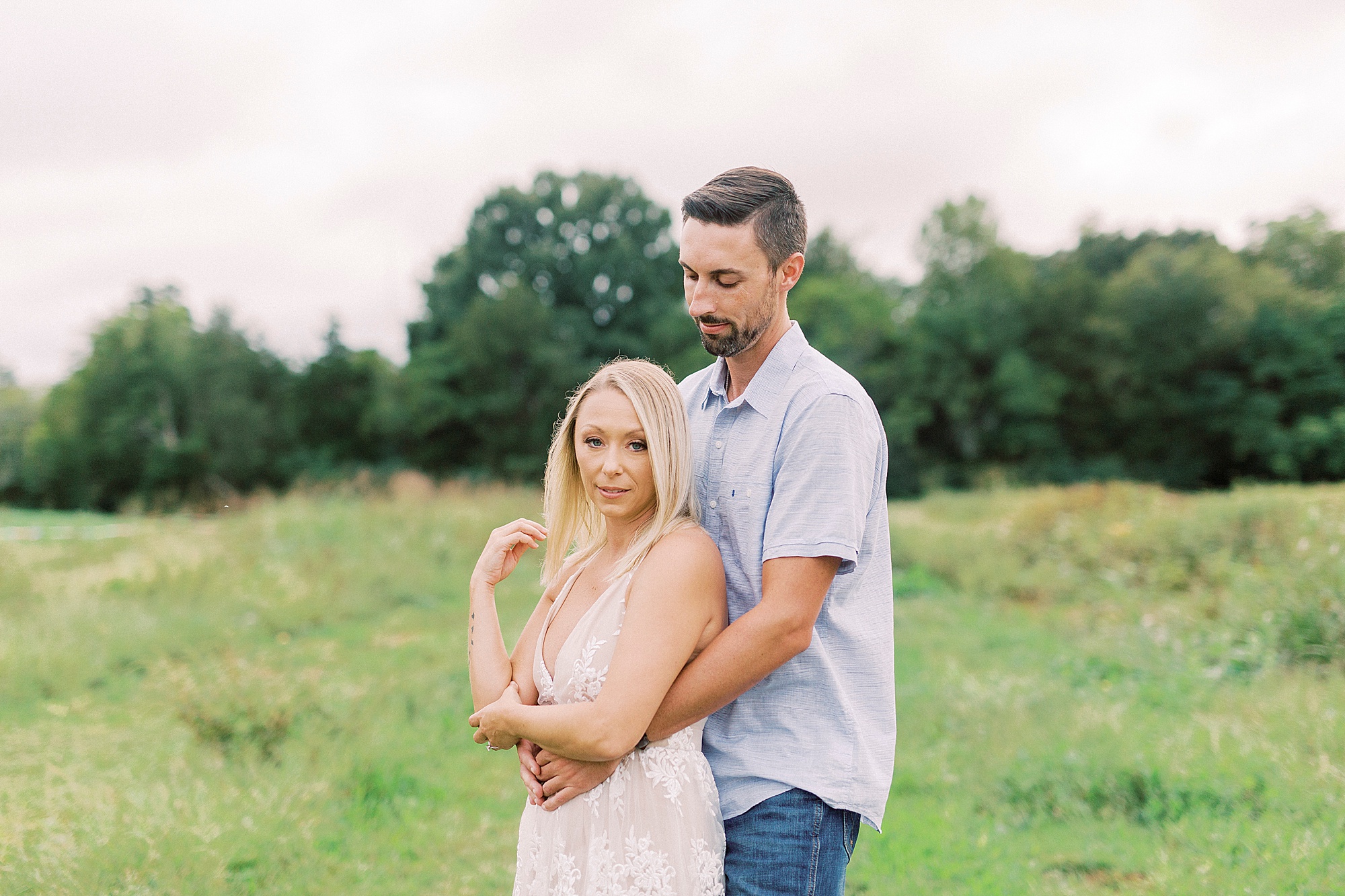 groom hugs bride during fall engagement session at Hodges Family Farm