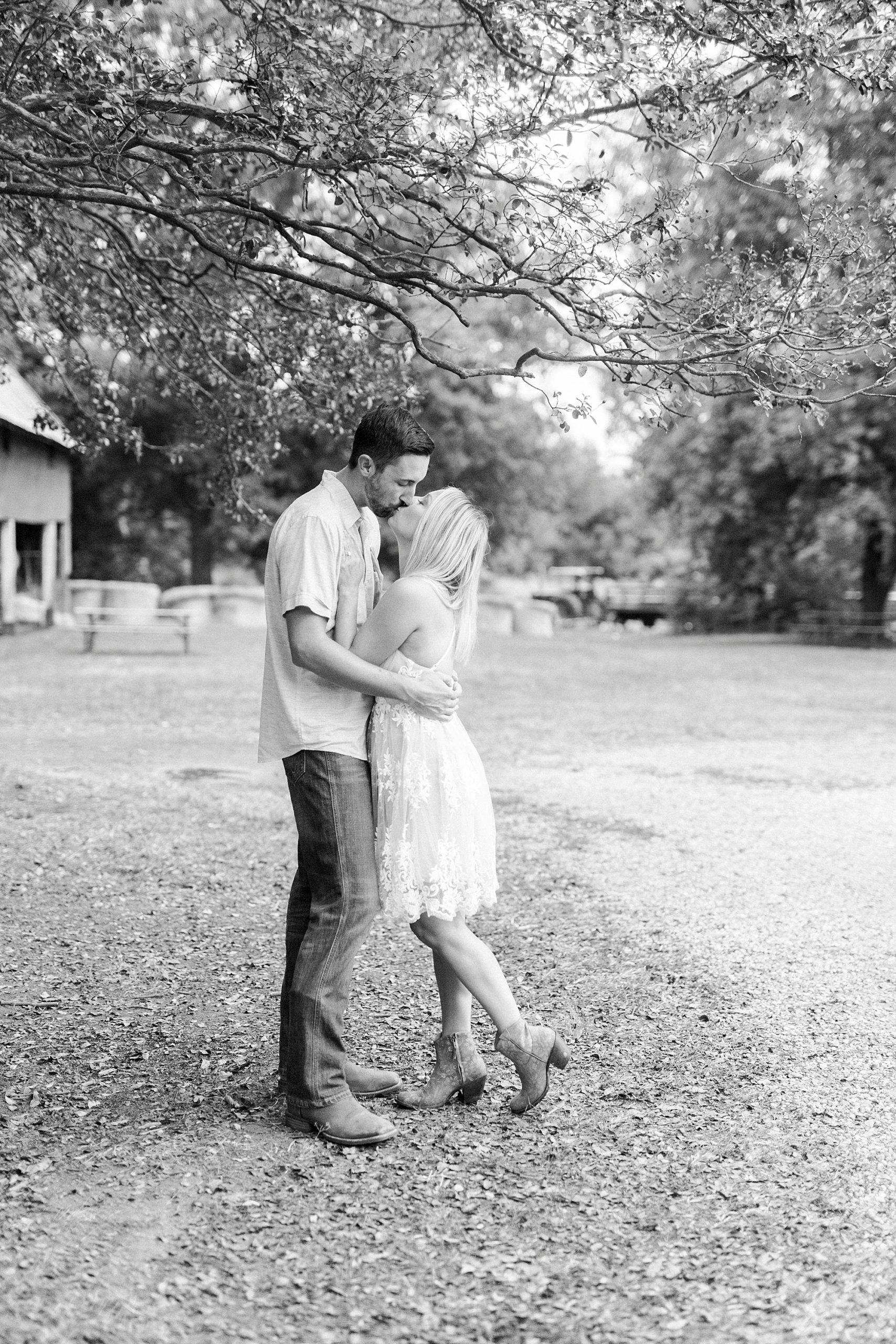 couple kisses during fall Hodges Family Farm engagement session