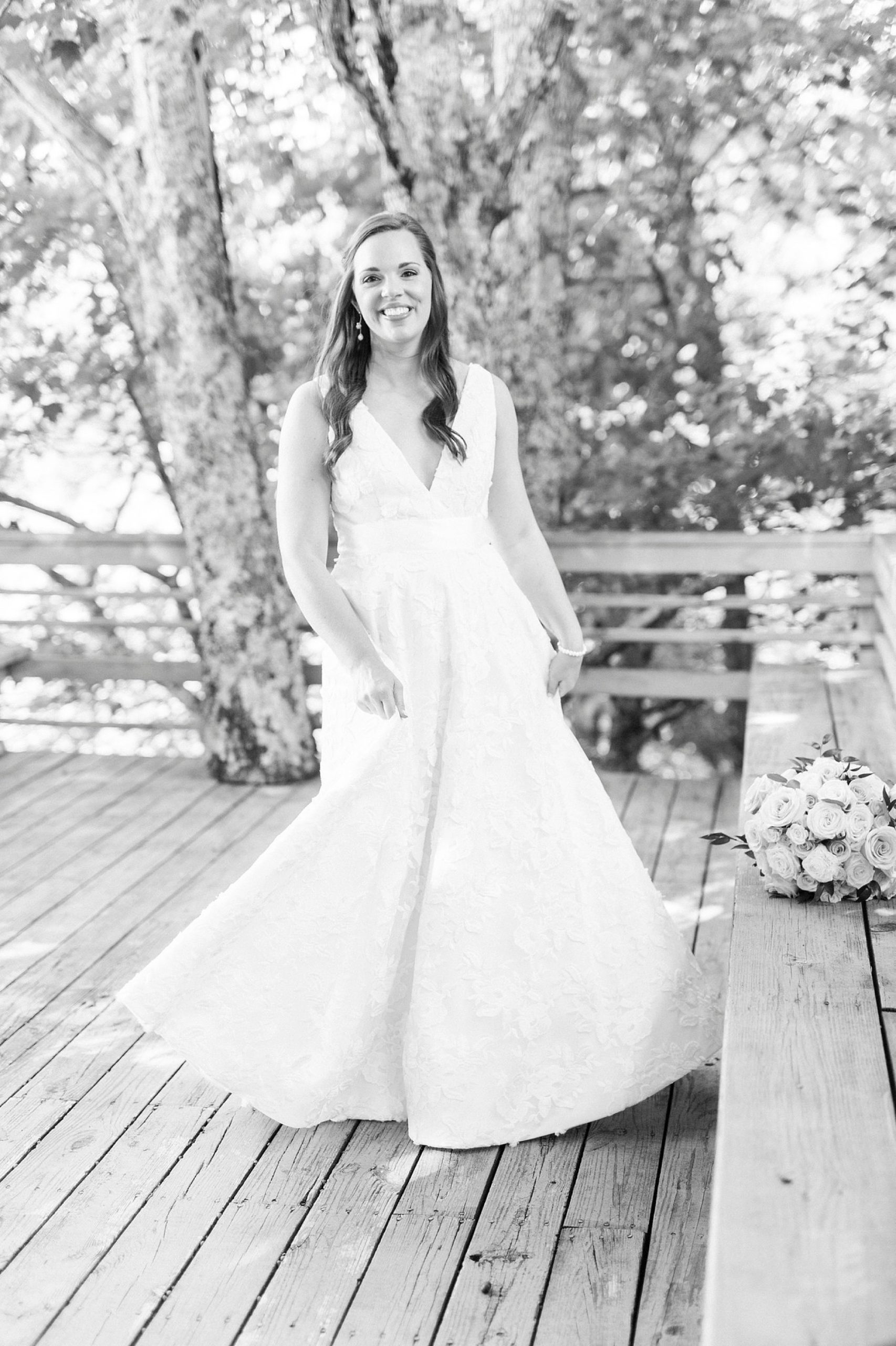 bride twirls wedding gown on back deck of the Inn at Crestwood