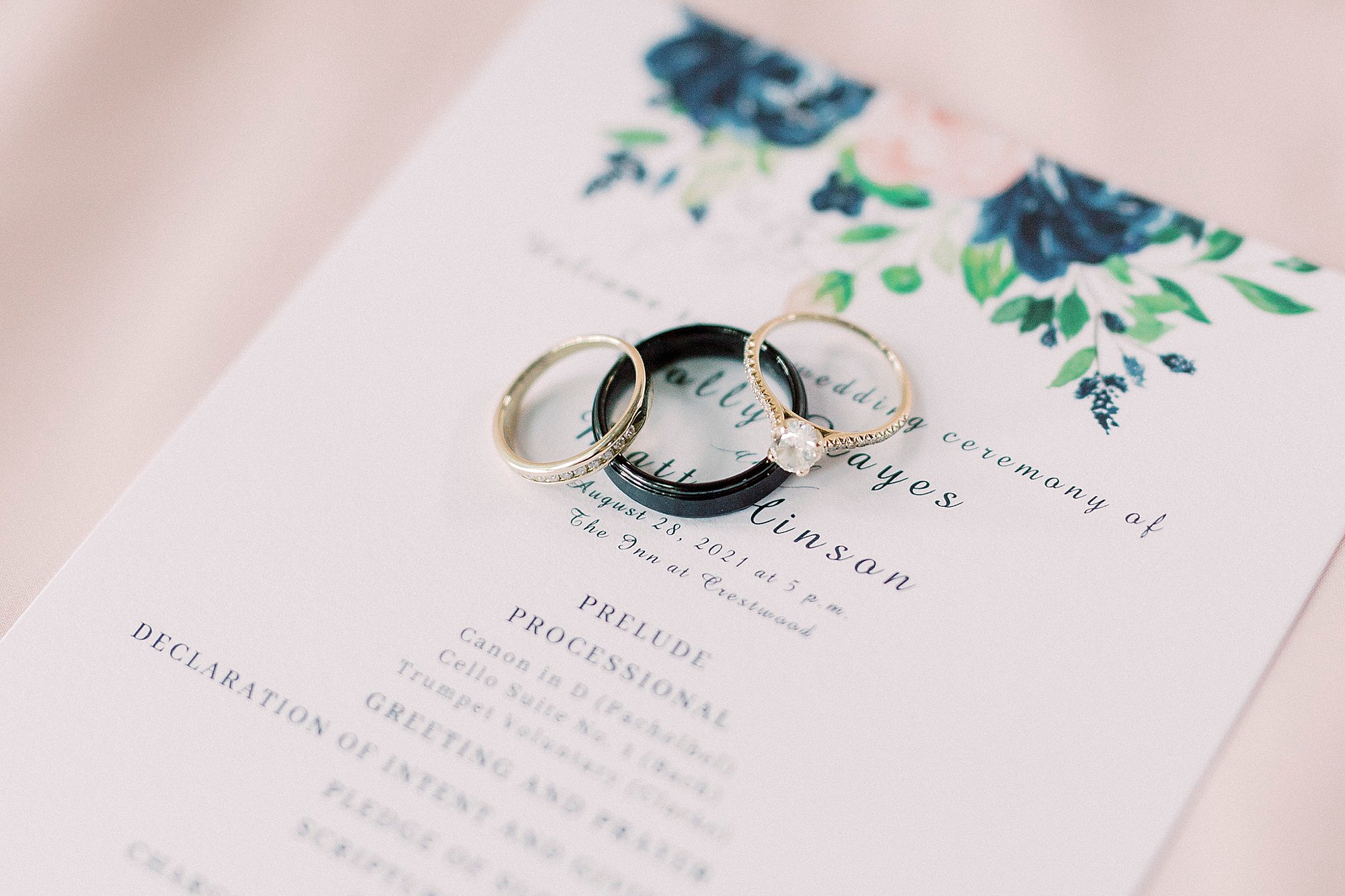 wedding rings lay on custom invitation for summer wedding