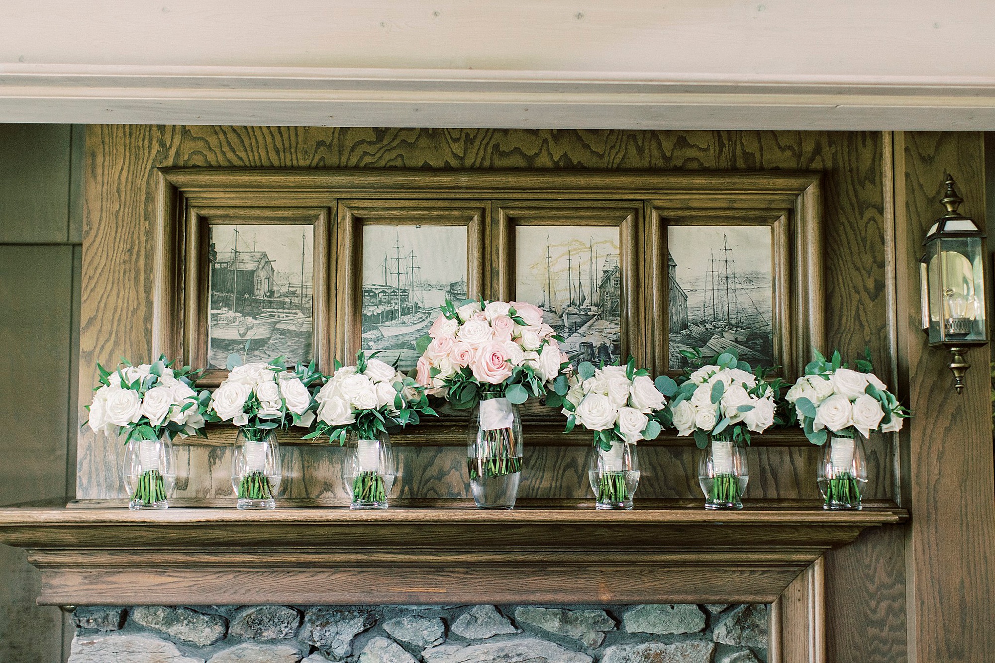 bouquets sit on stone fireplace at the Inn at Crestwood