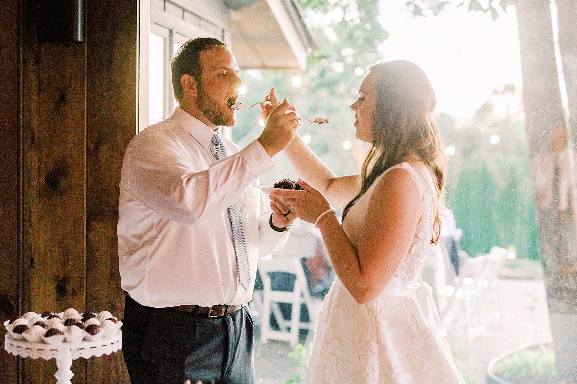 bride and groom feed each other cake during Blowing Rock NC wedding reception