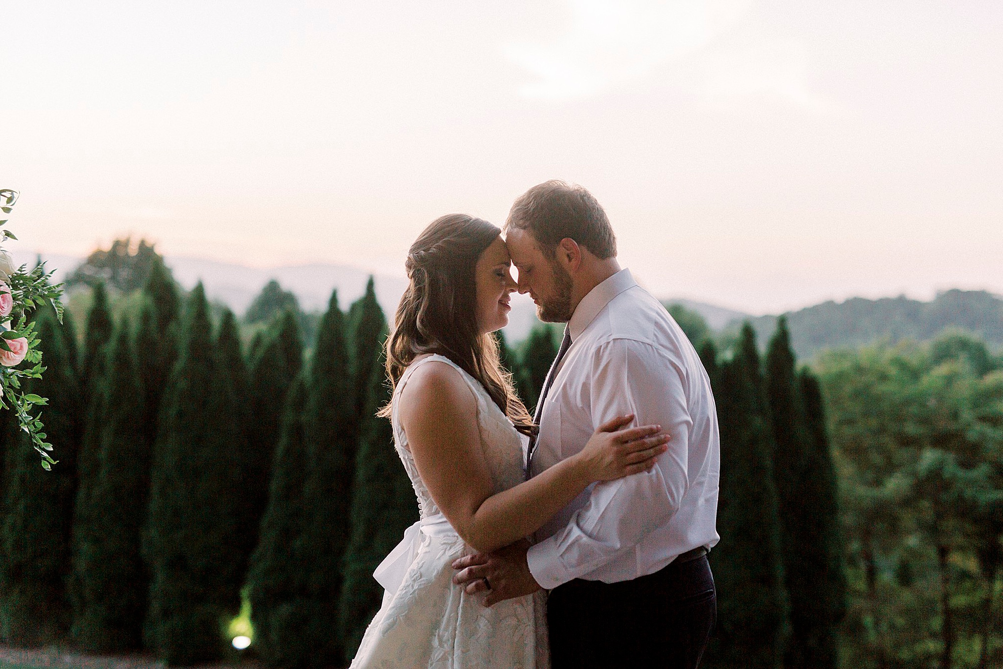 bride and groom pose on mountaintop in Blowing Rock NC