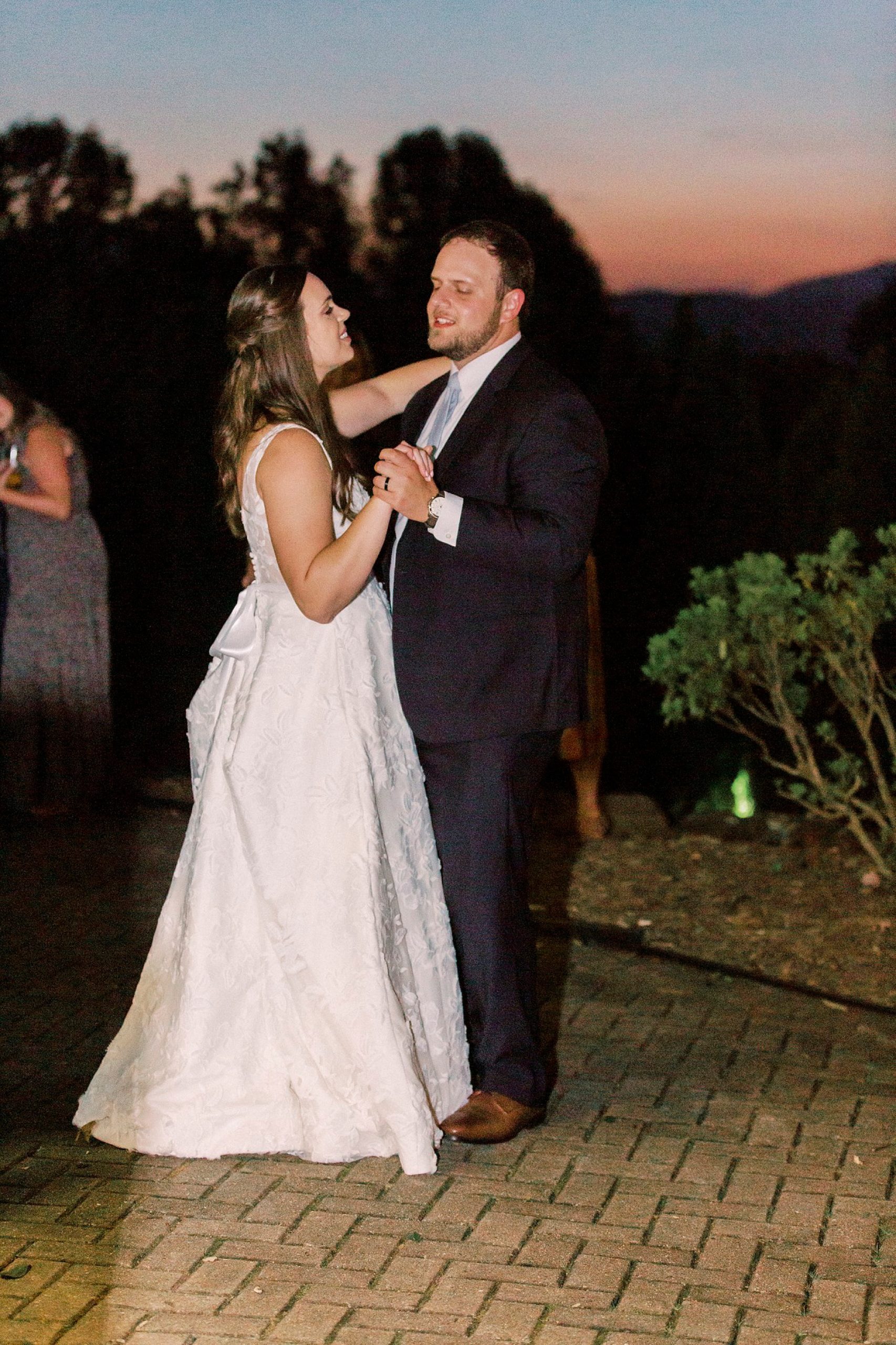 bride and groom dance at sunset during Blowing Rock NC wedding reception