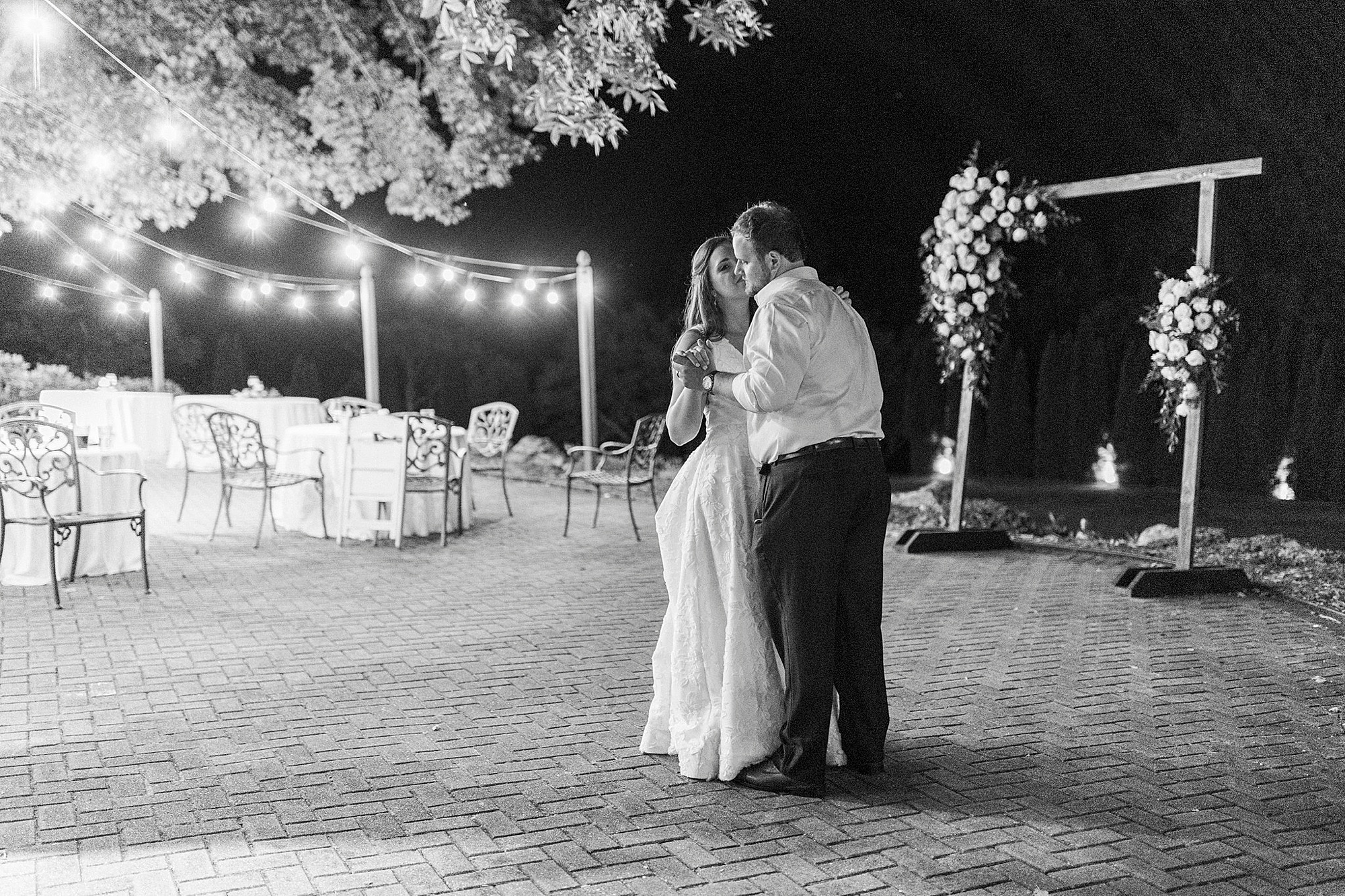 newlyweds dance near lights at Blowing Rock NC wedding reception