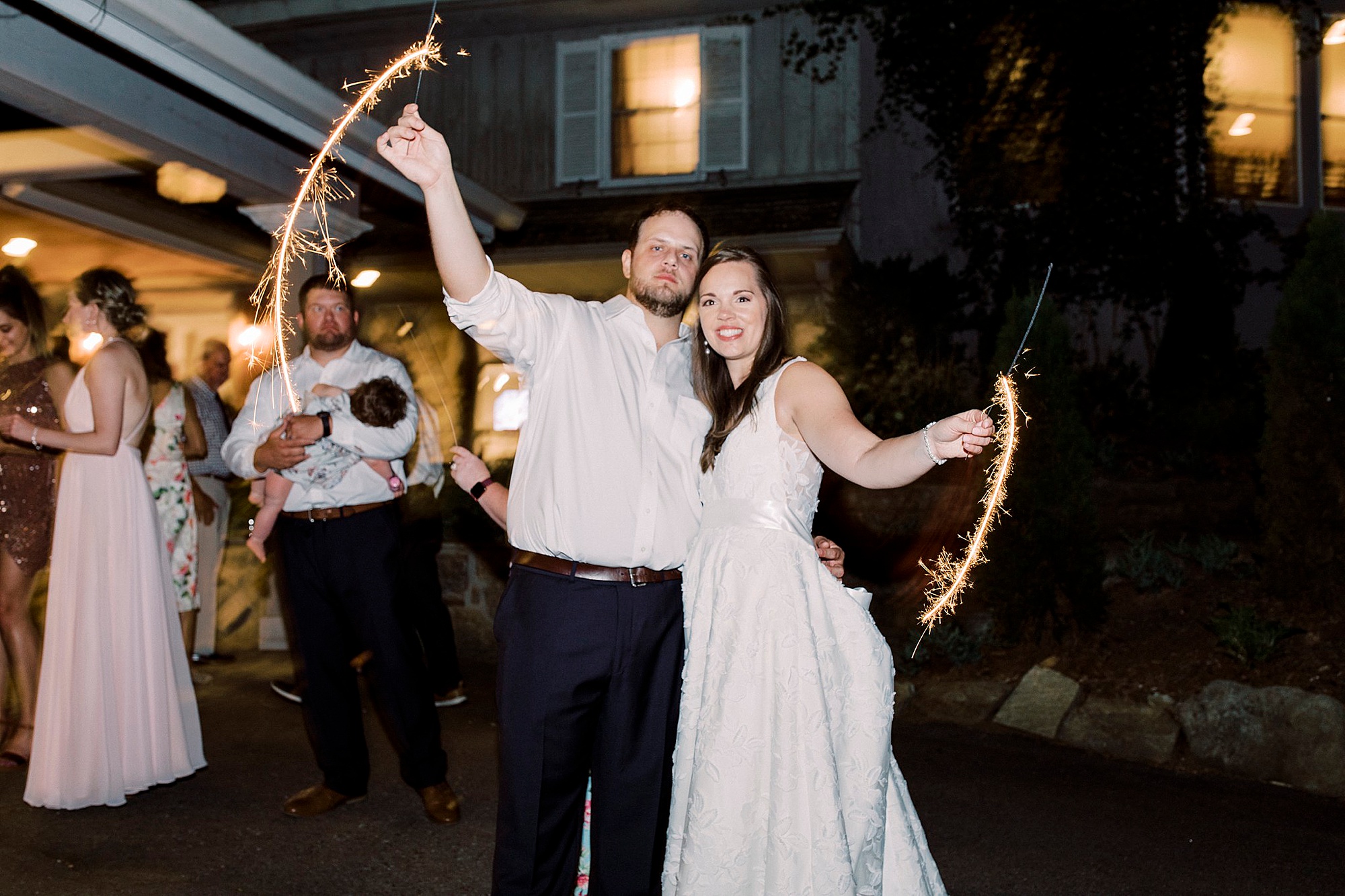 bride and groom move sparklers during exit