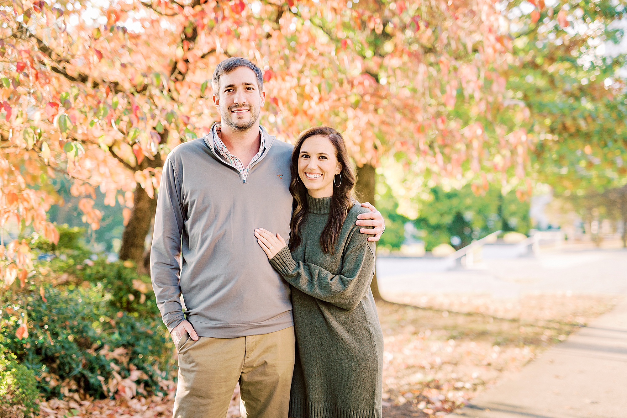 engaged couple hugs under fall leaves during Marshall Park engagement session