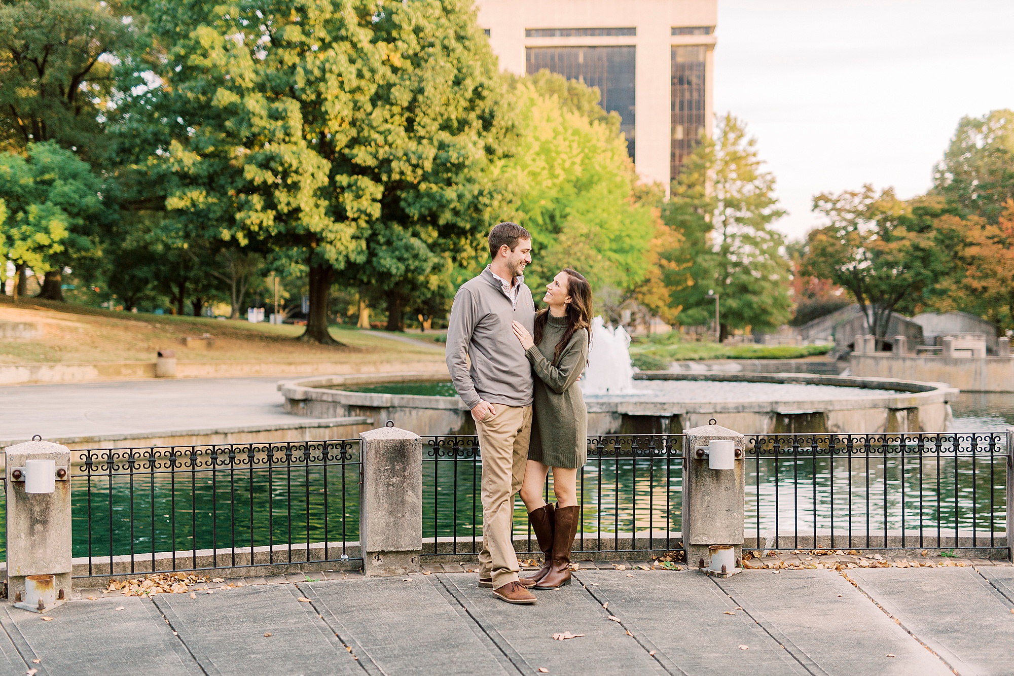bride and groom pose by fountain during Marshall Park engagement session