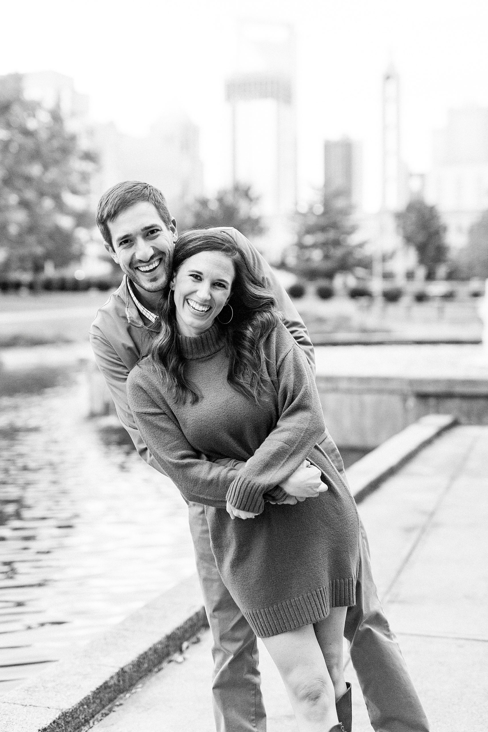couple hugs laughing along pond in Marshall Park