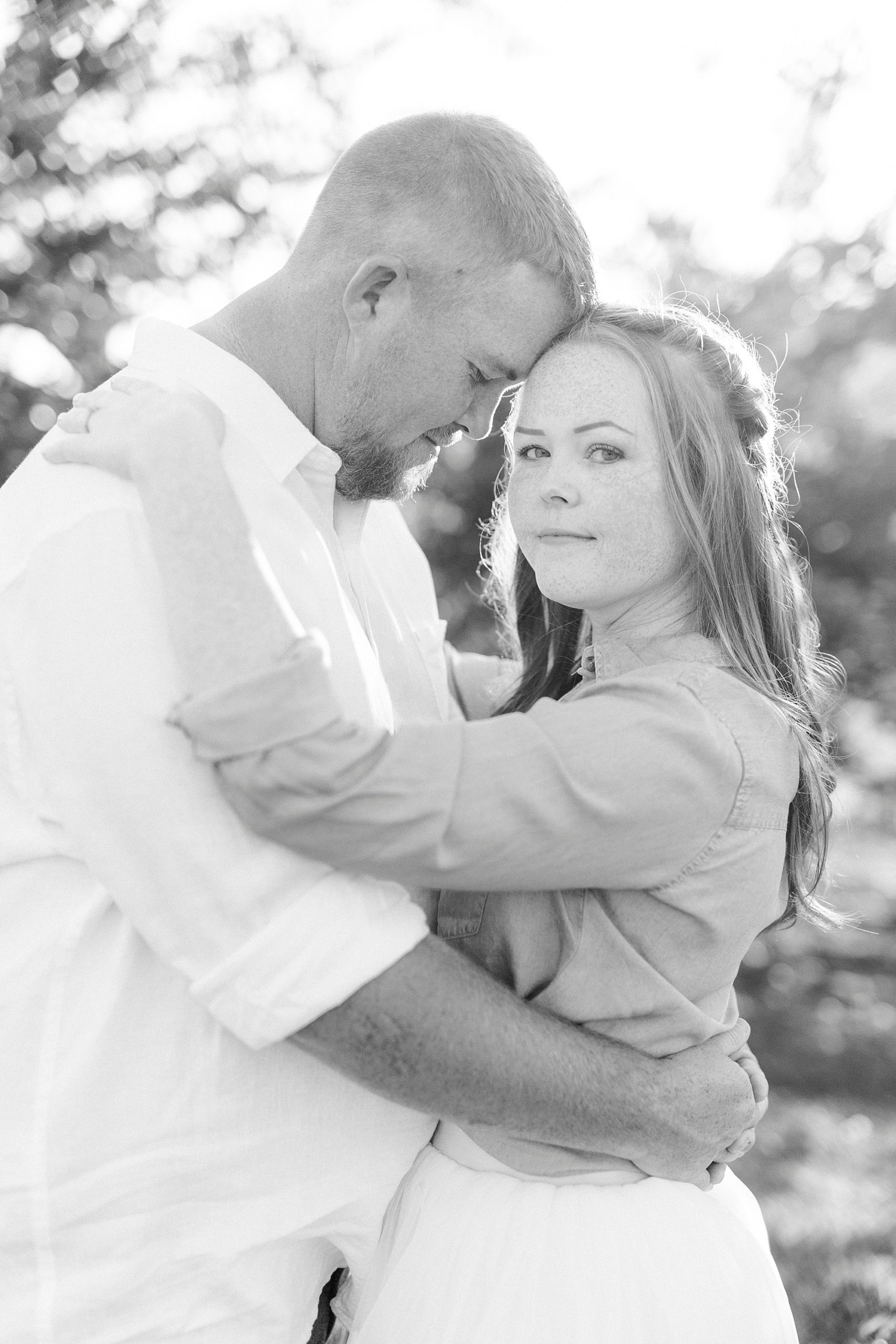 bride and groom touch heads during NC engagement photos