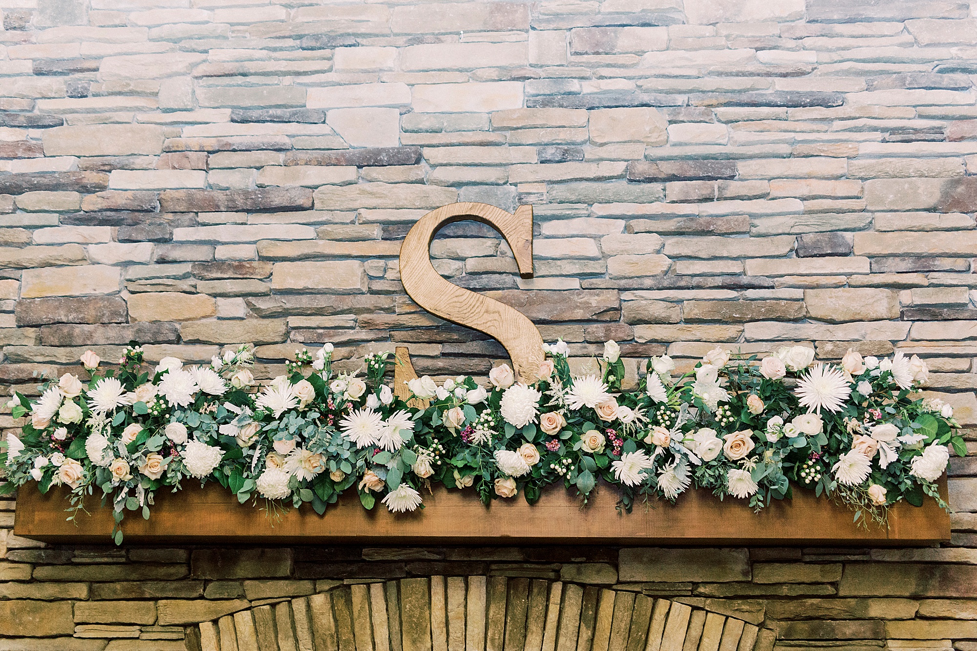 "S" sits on mantle at Addison Farm wedding reception
