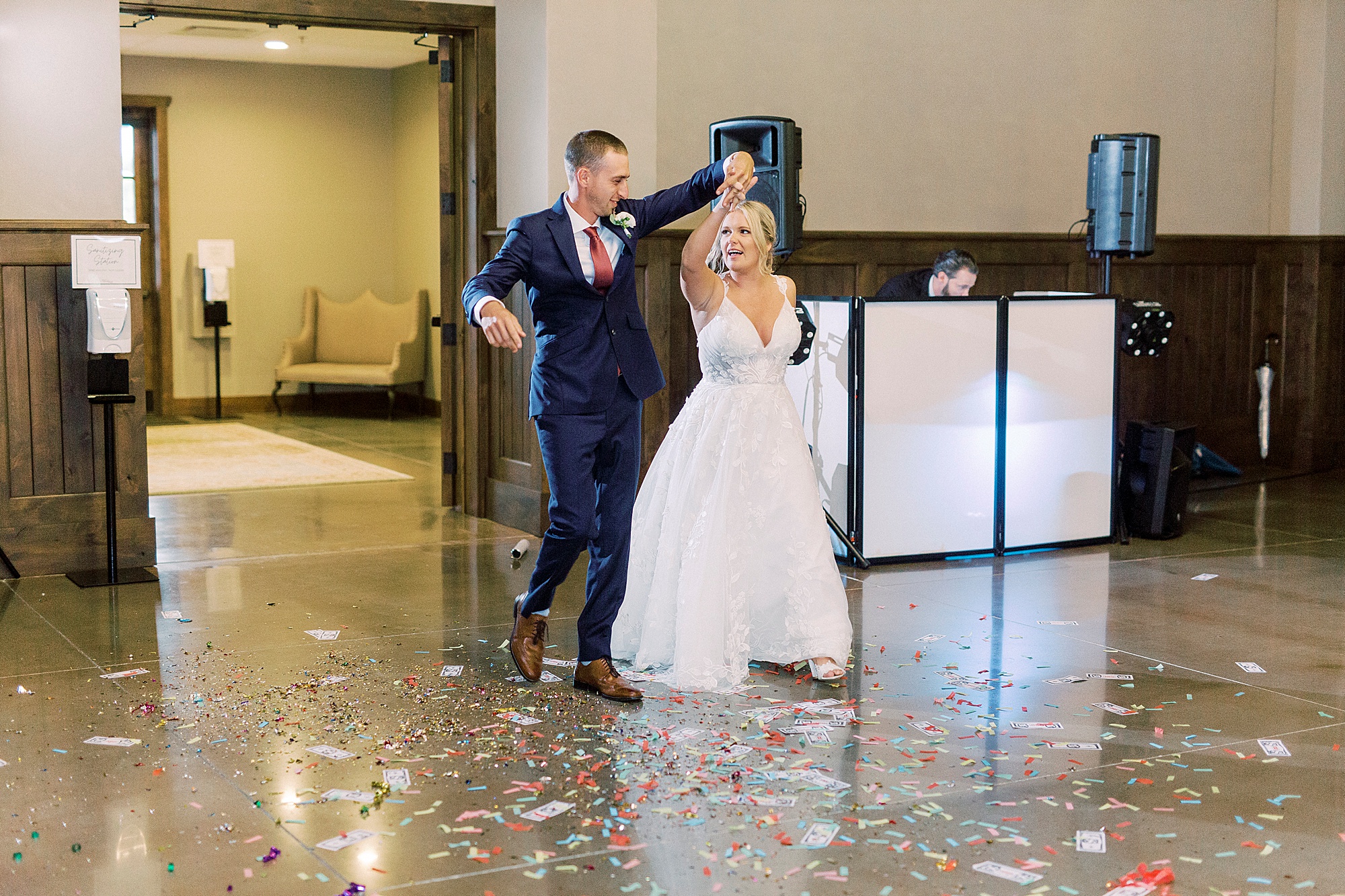 couple celebrates walking into Greensboro NC wedding reception
