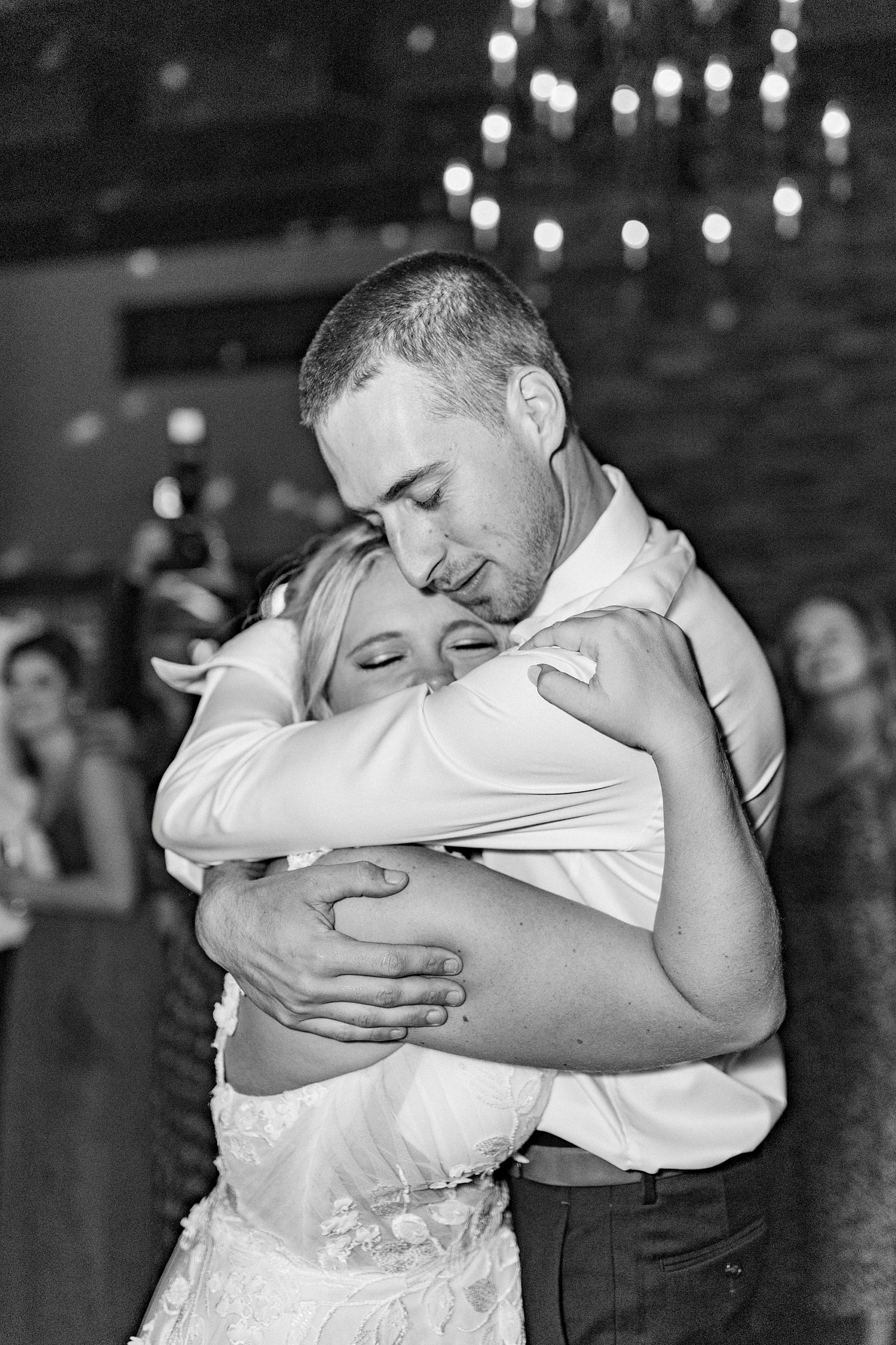 groom hugs bride during dance at Greensboro NC wedding reception