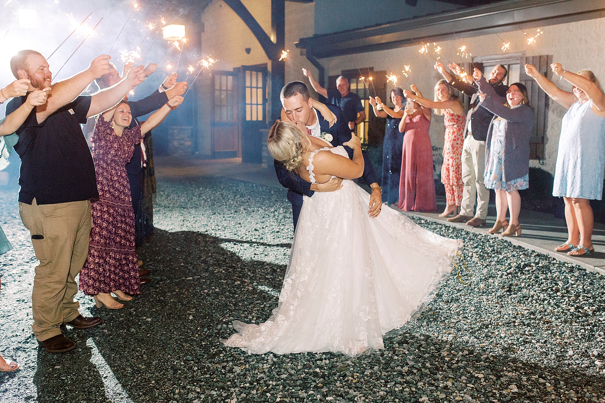 groom dips bride during sparkler exit from Greensboro NC wedding reception