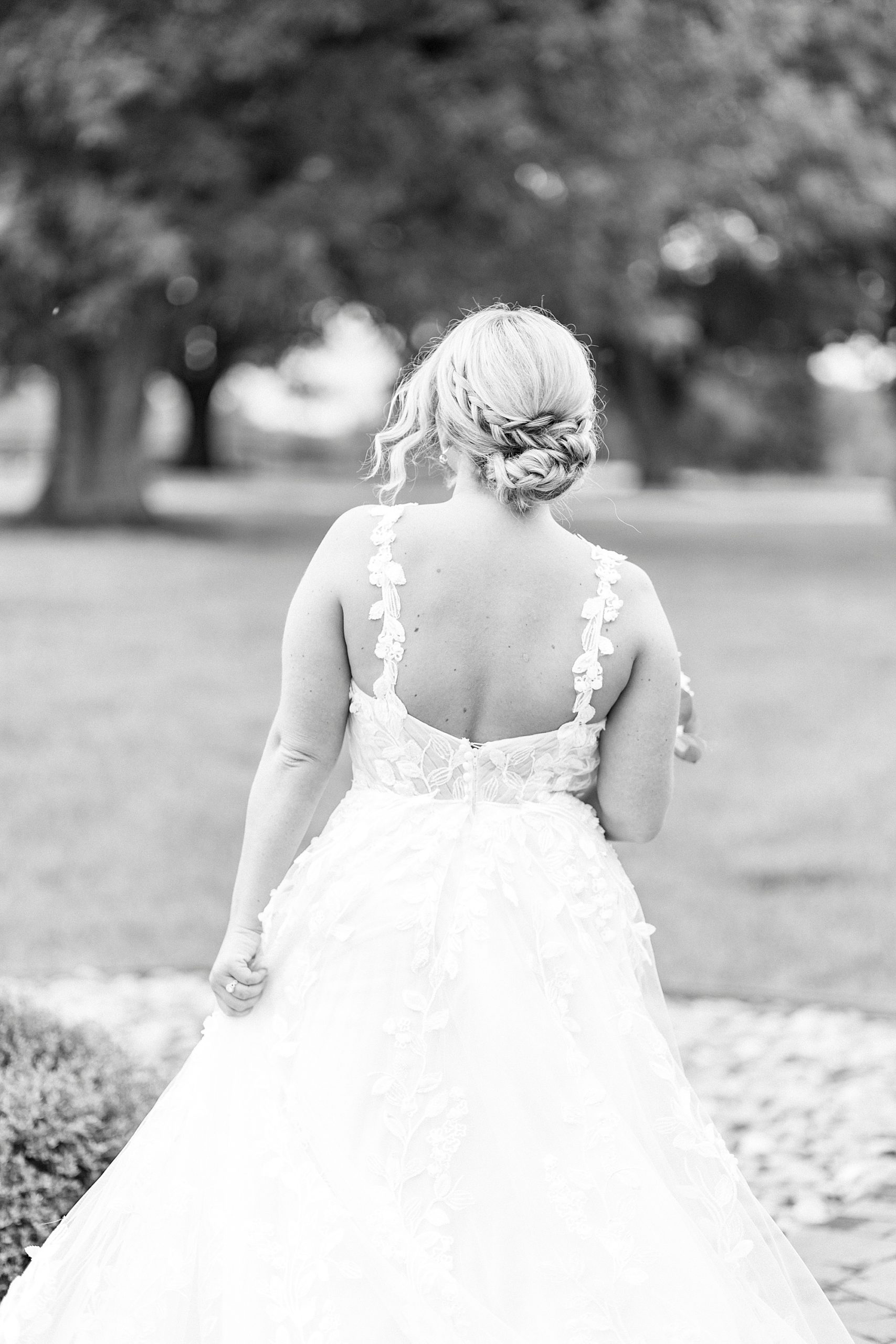 bride shows off lace back of gown