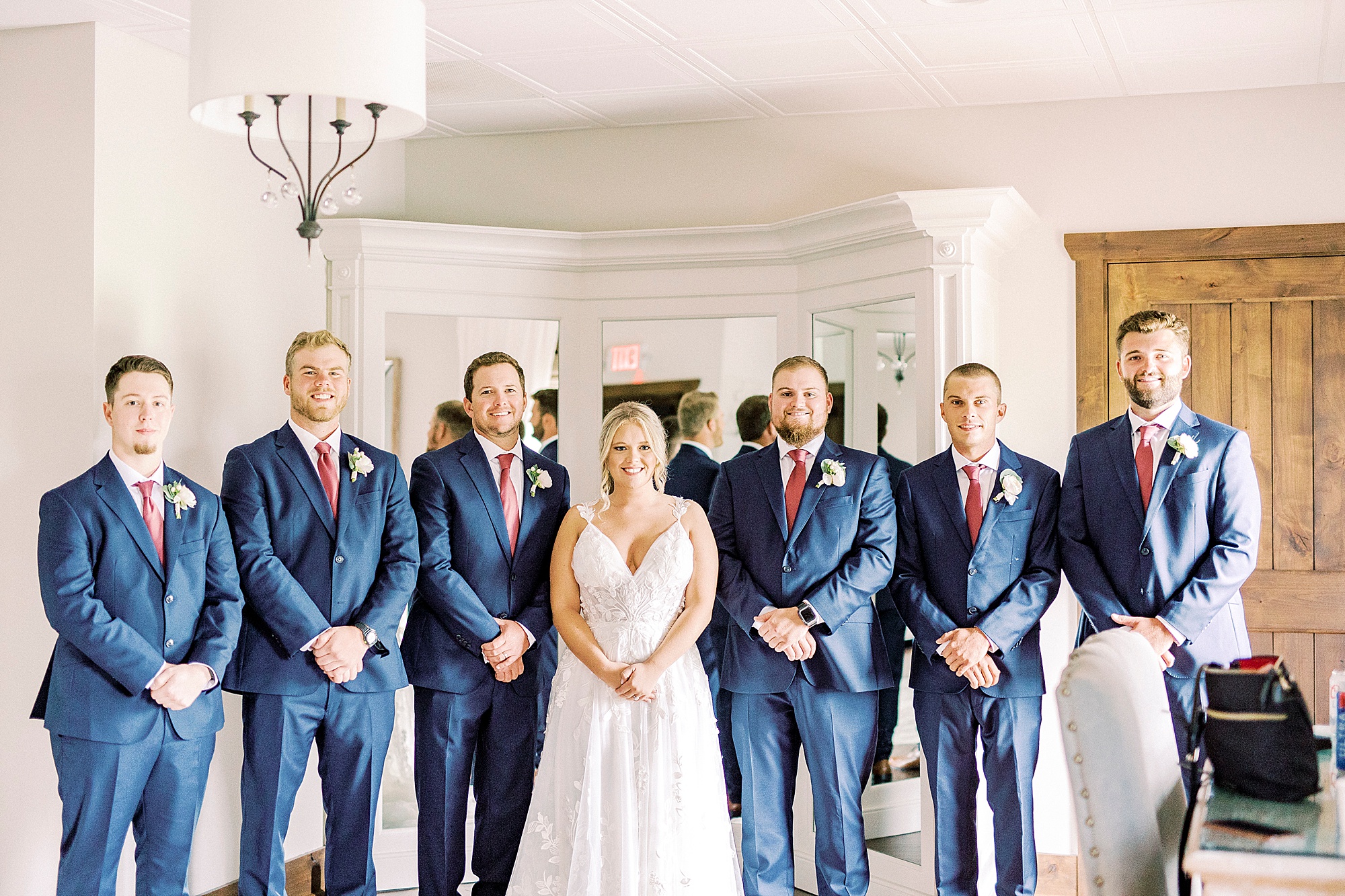 bride poses with brothers after first look