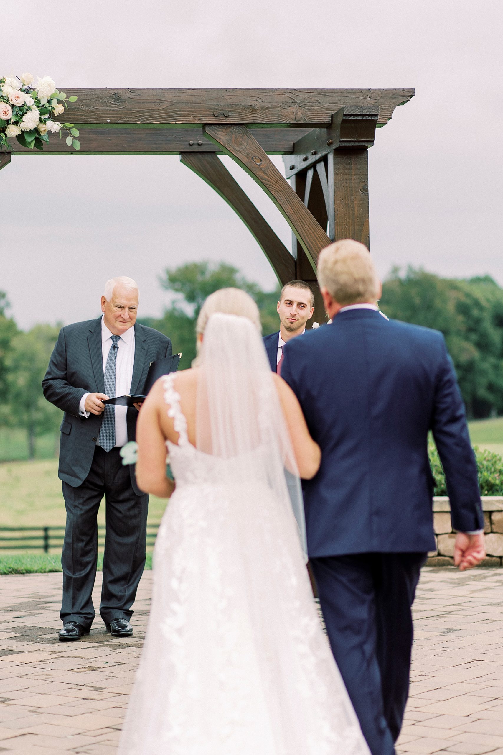 bride walks down aisle for outdoor ceremony on farm in Greensboro NC