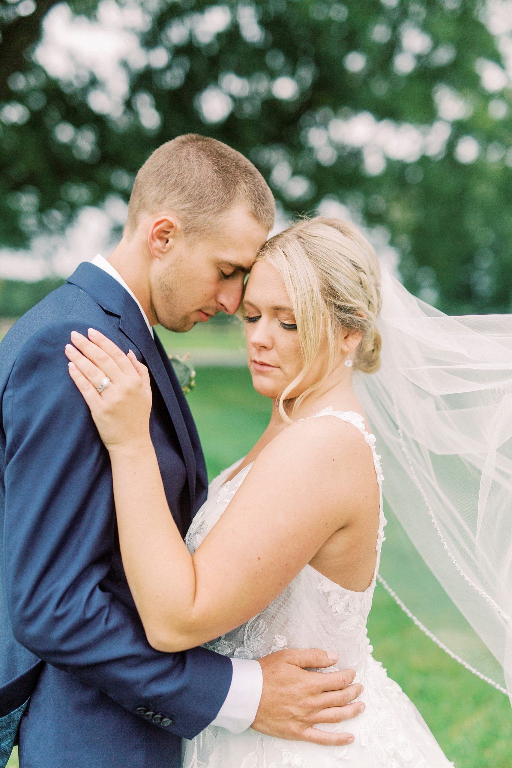 newlyweds pose with foreheads touching at Addison Farm