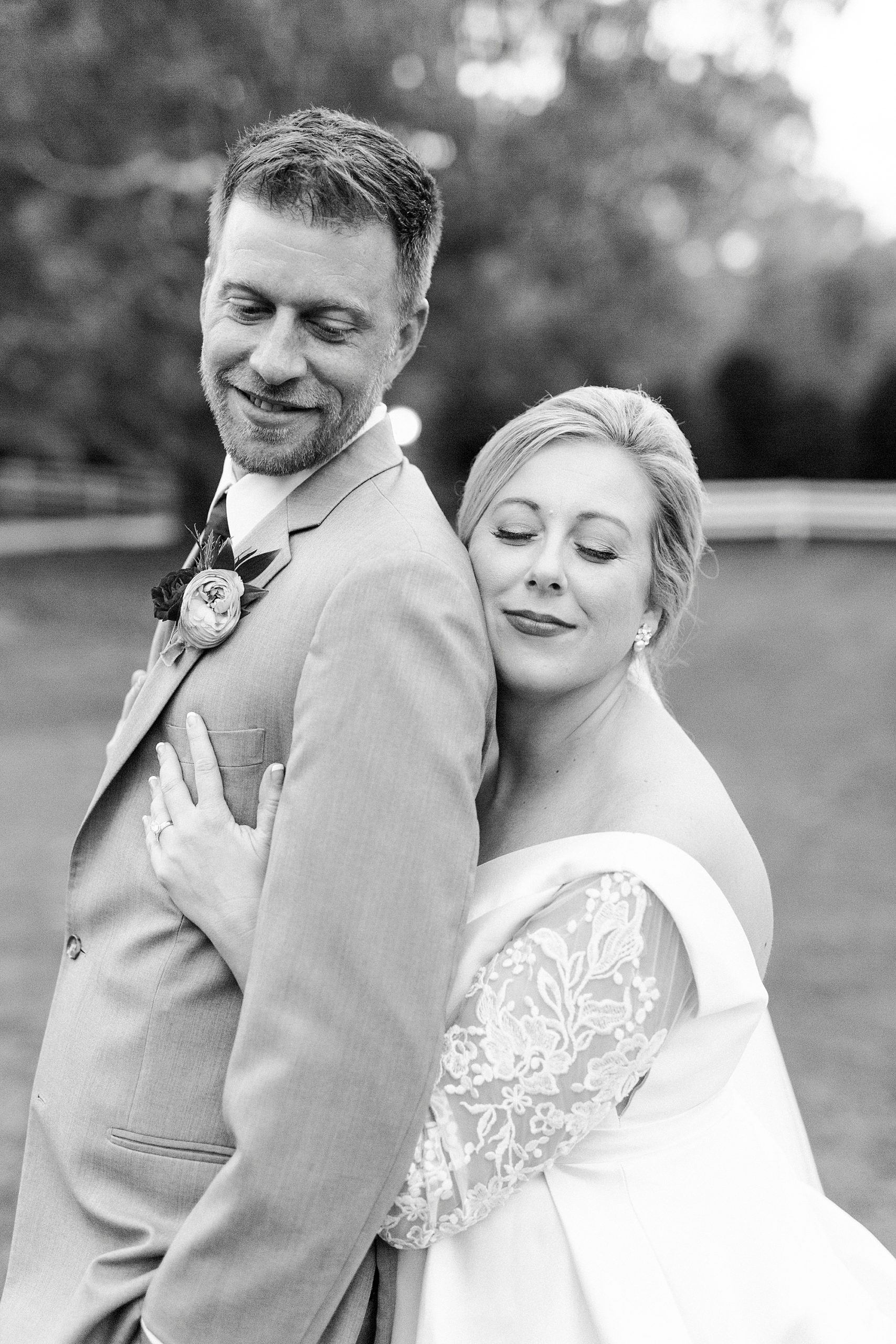 bride leans into groom's back during NC wedding portraits