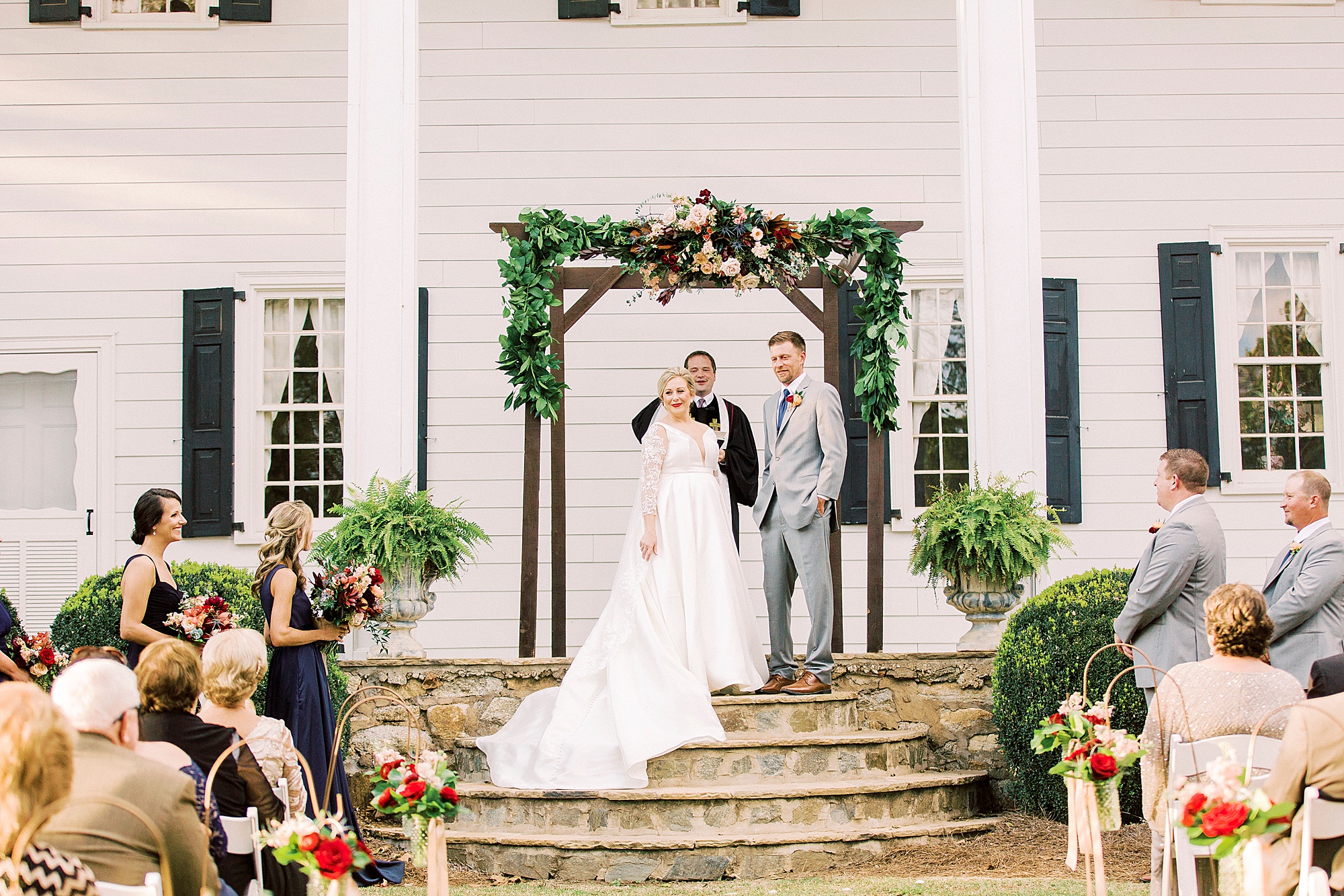 bride looks at guests during NC wedding ceremony at vineyard