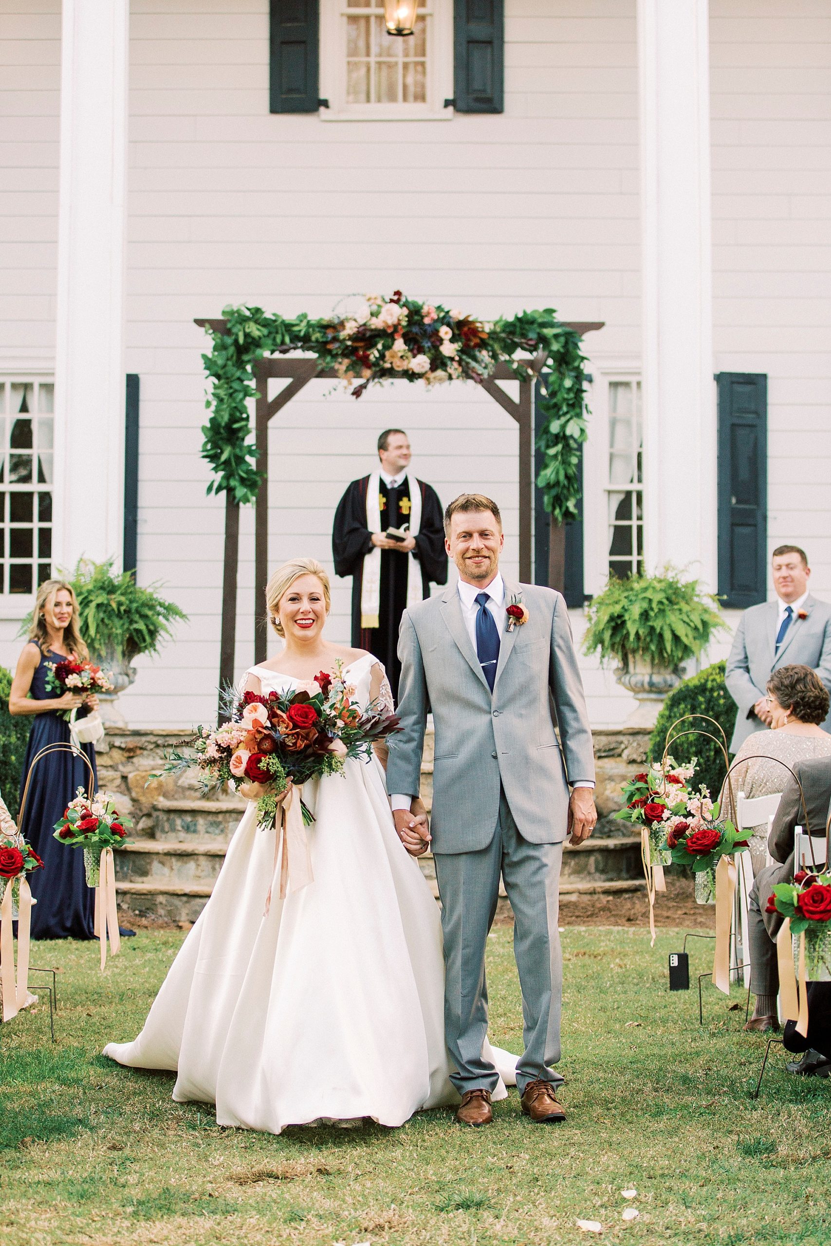 bride and groom walk up aisle during NC wedding ceremony at vineyard