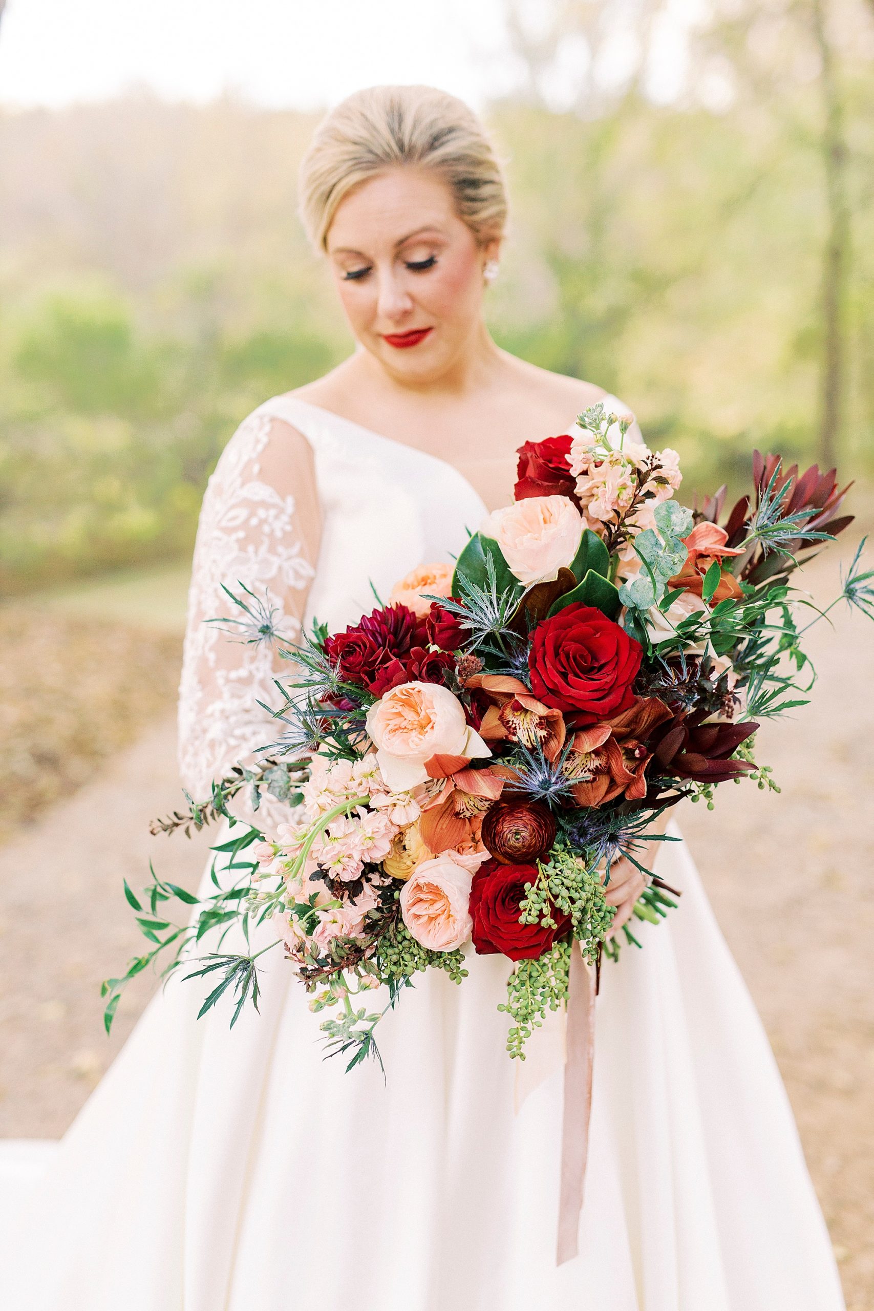fall bridal portraits at Vesuvius Vineyards with bride holding bouquet of red flowers