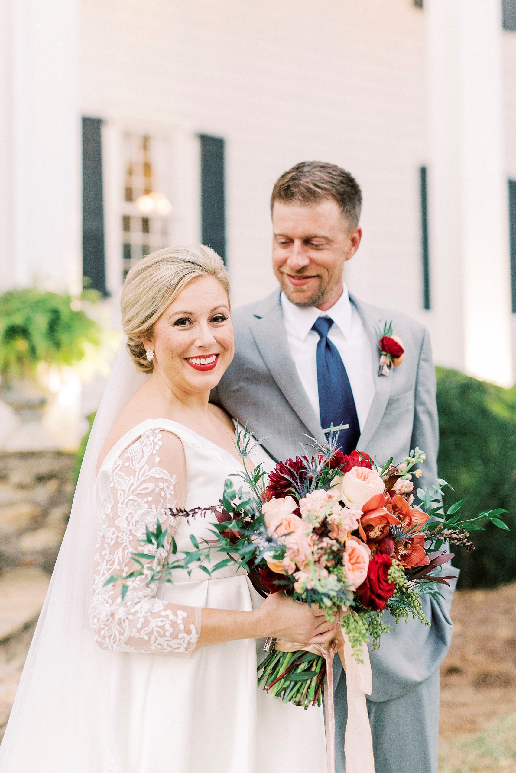 groom smiles at bride during fall wedding portraits