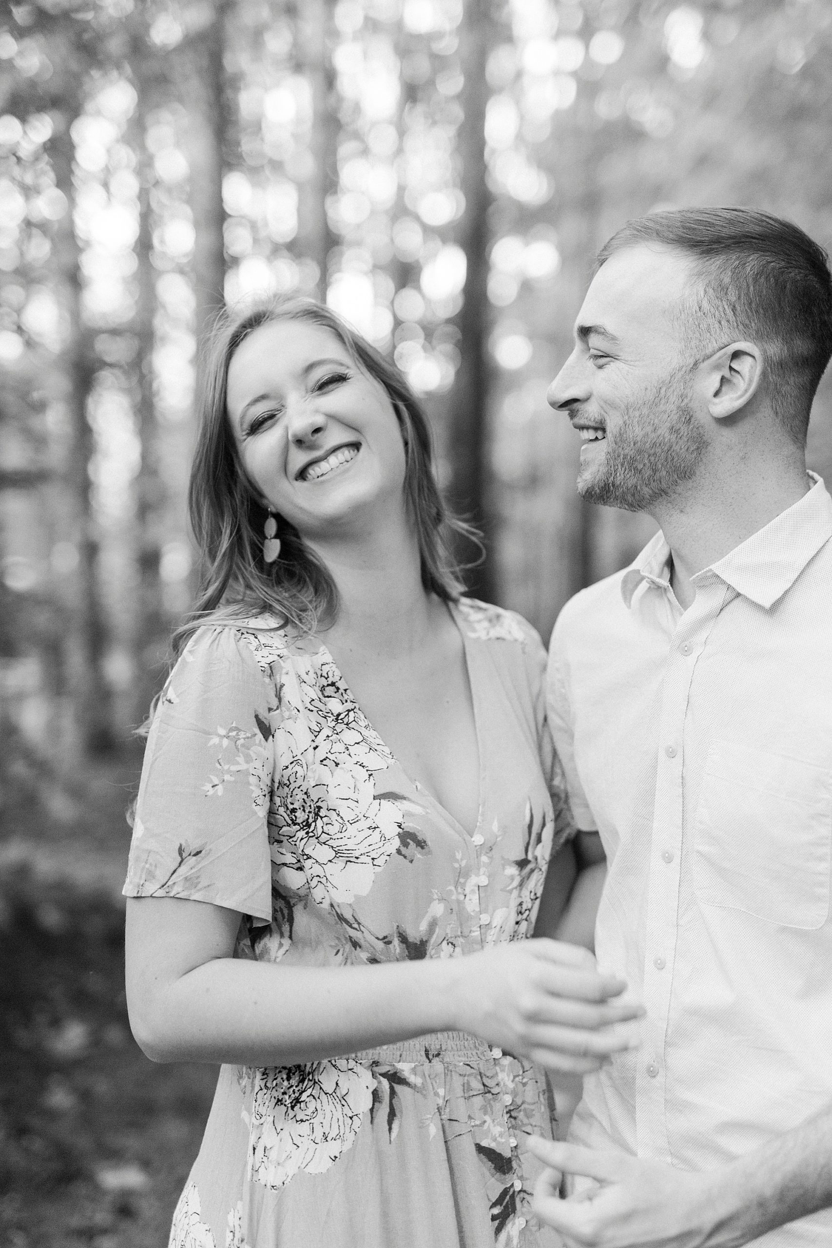 groom makes bride laugh during fall Whitewater Center engagement session