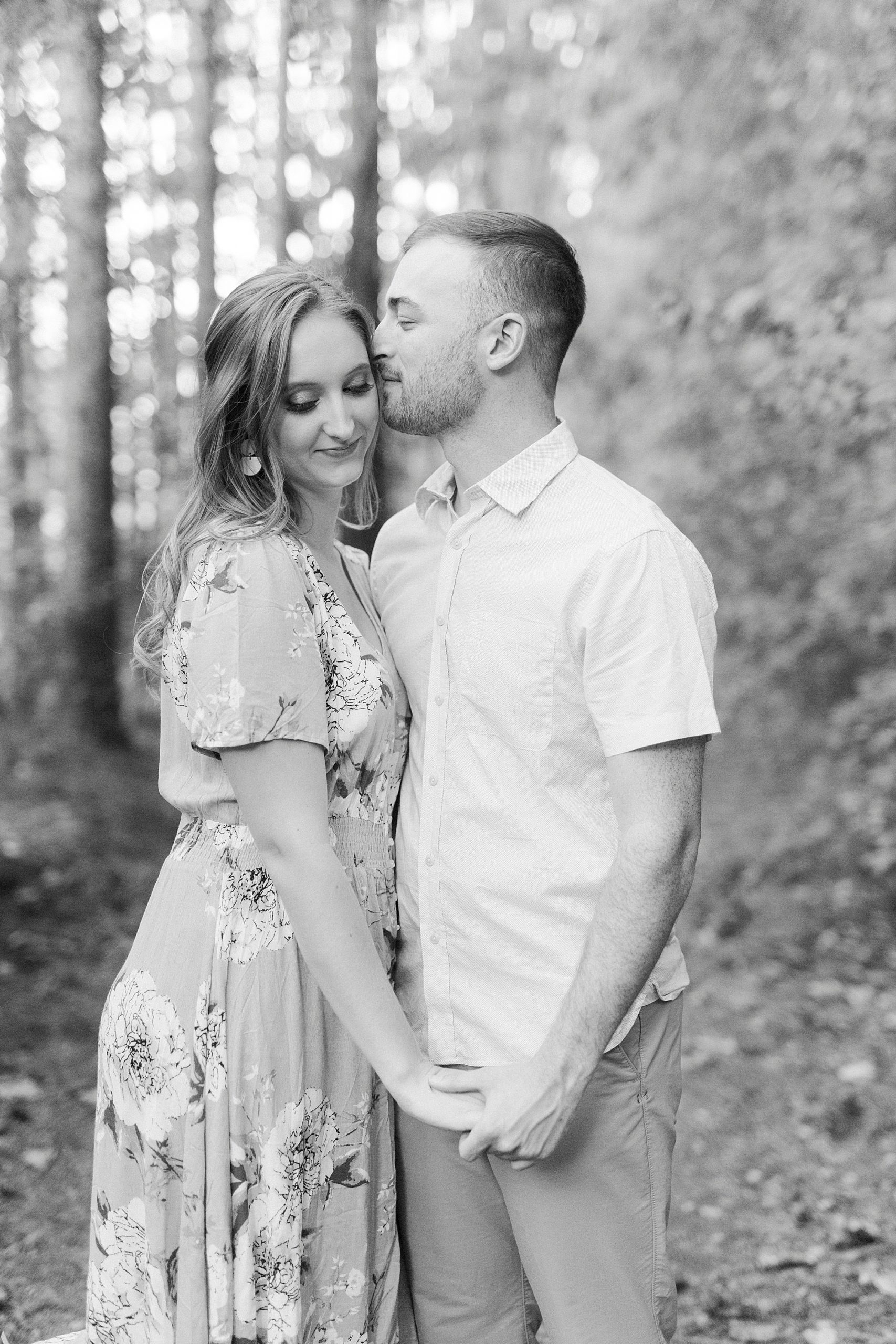 groom kisses bride's forehead during NC engagement portraits