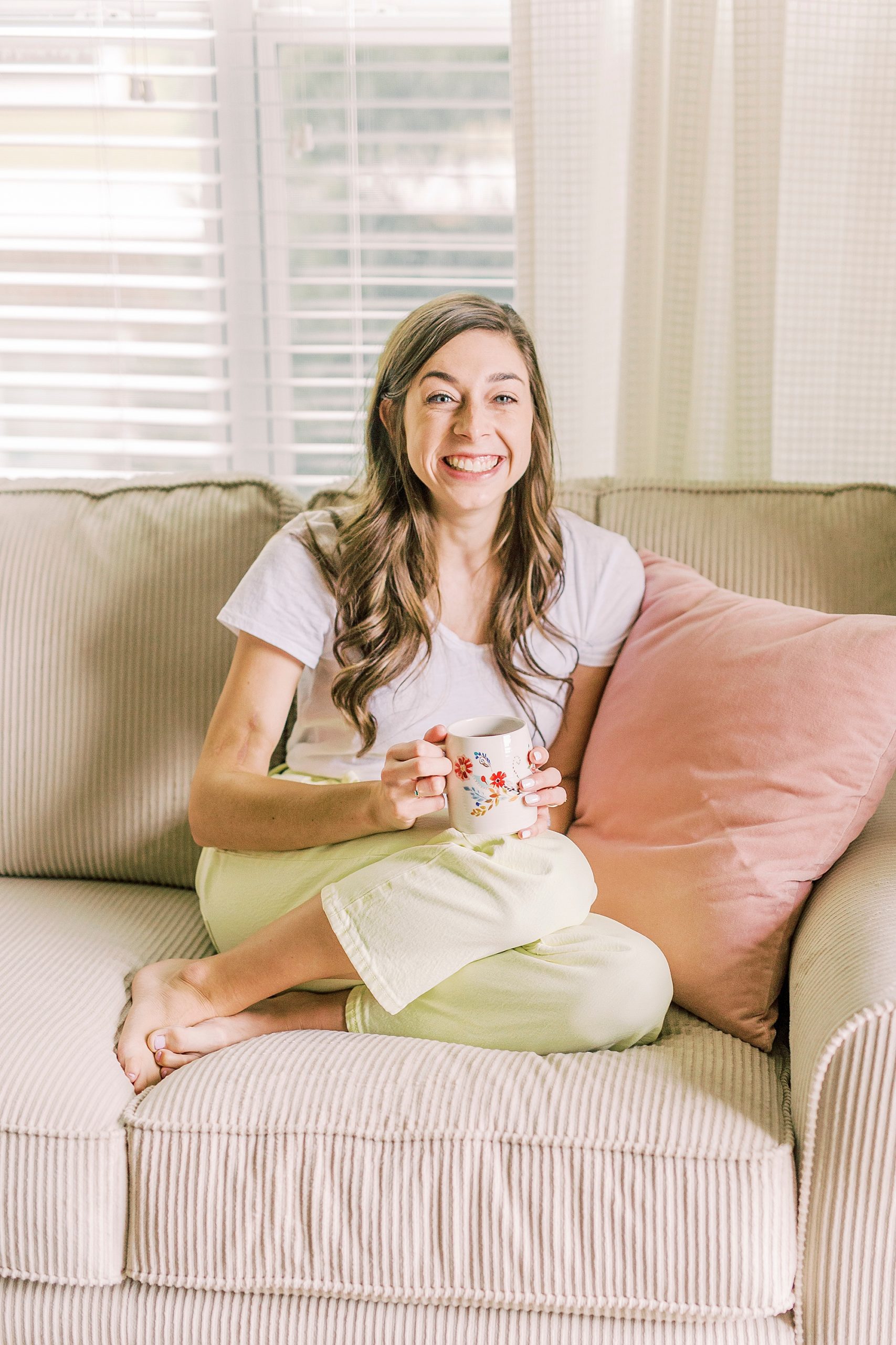 woman sits on couch during at home branding photos in Charlotte NC