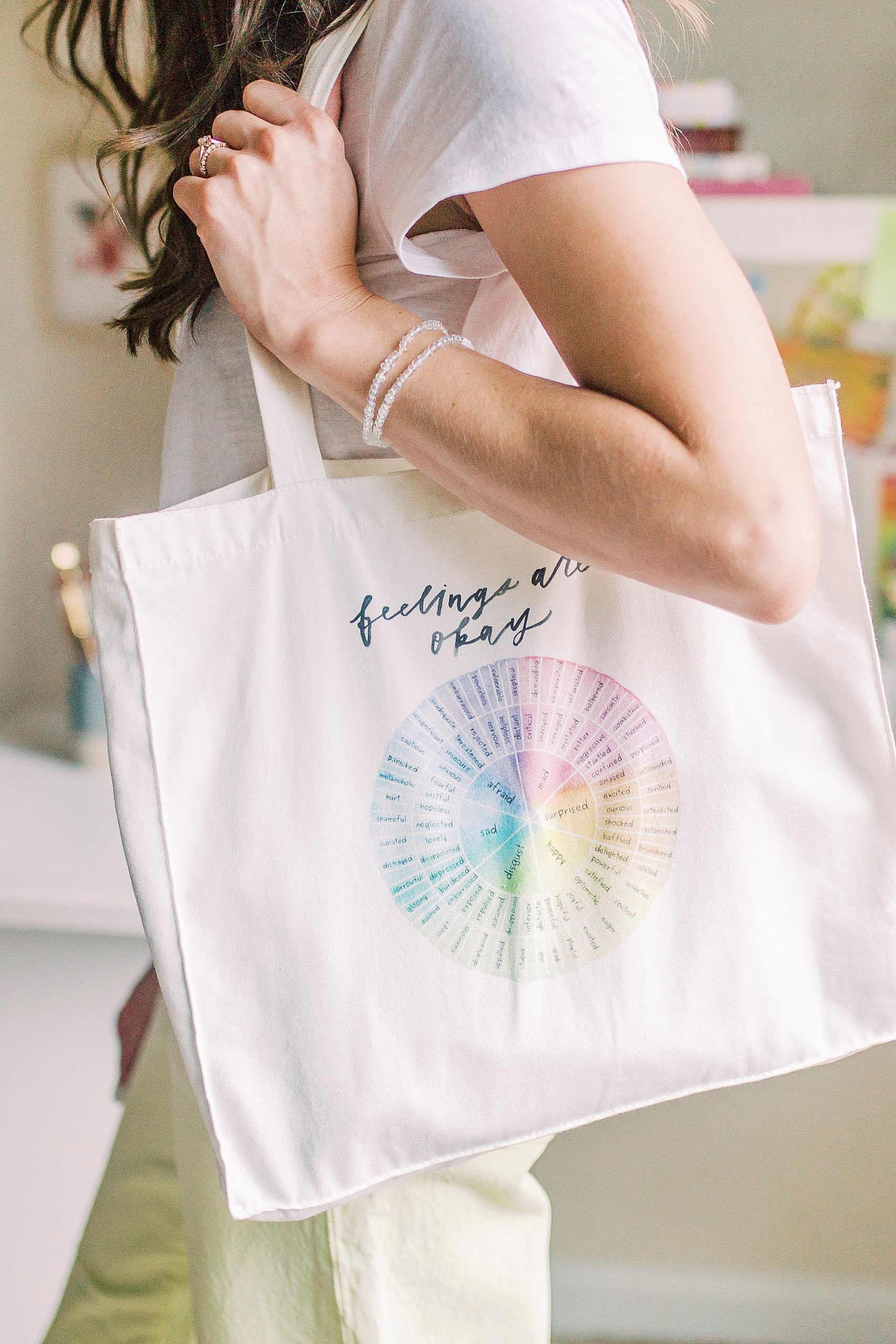 woman carries bag with color wheel